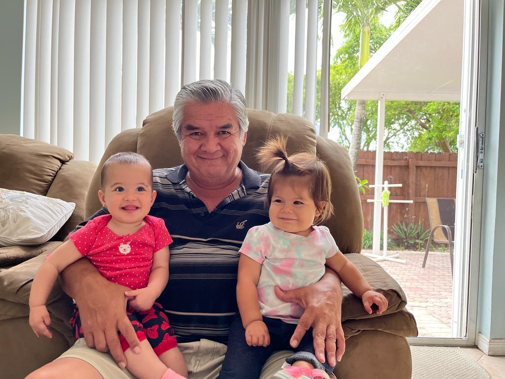 A man holding two children