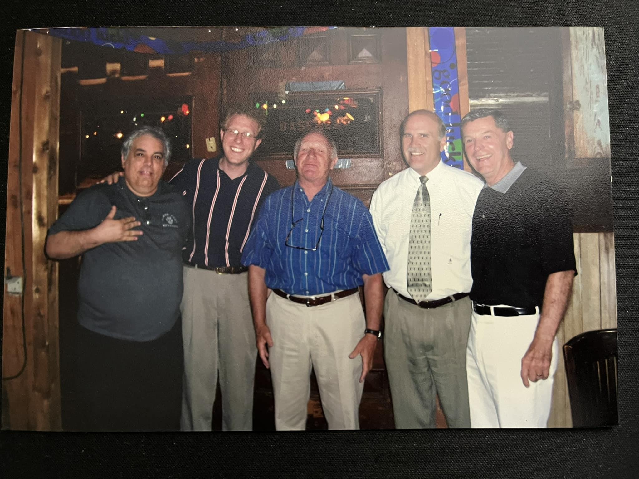 A group of men posing for a photo
