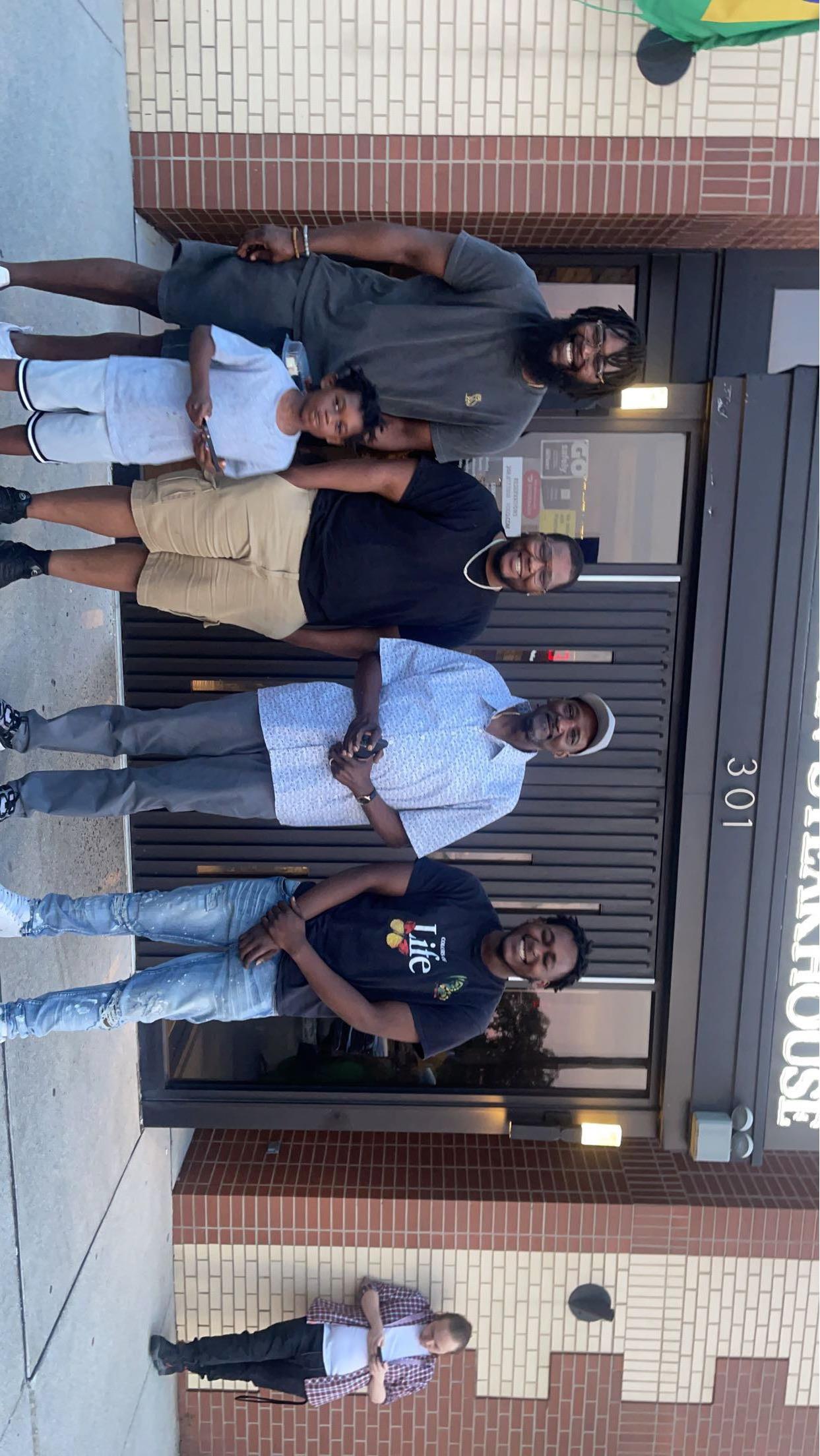 A group of men standing outside a restaurant