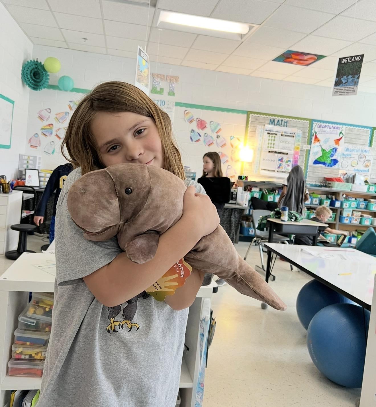 A girl holding a stuffed animal