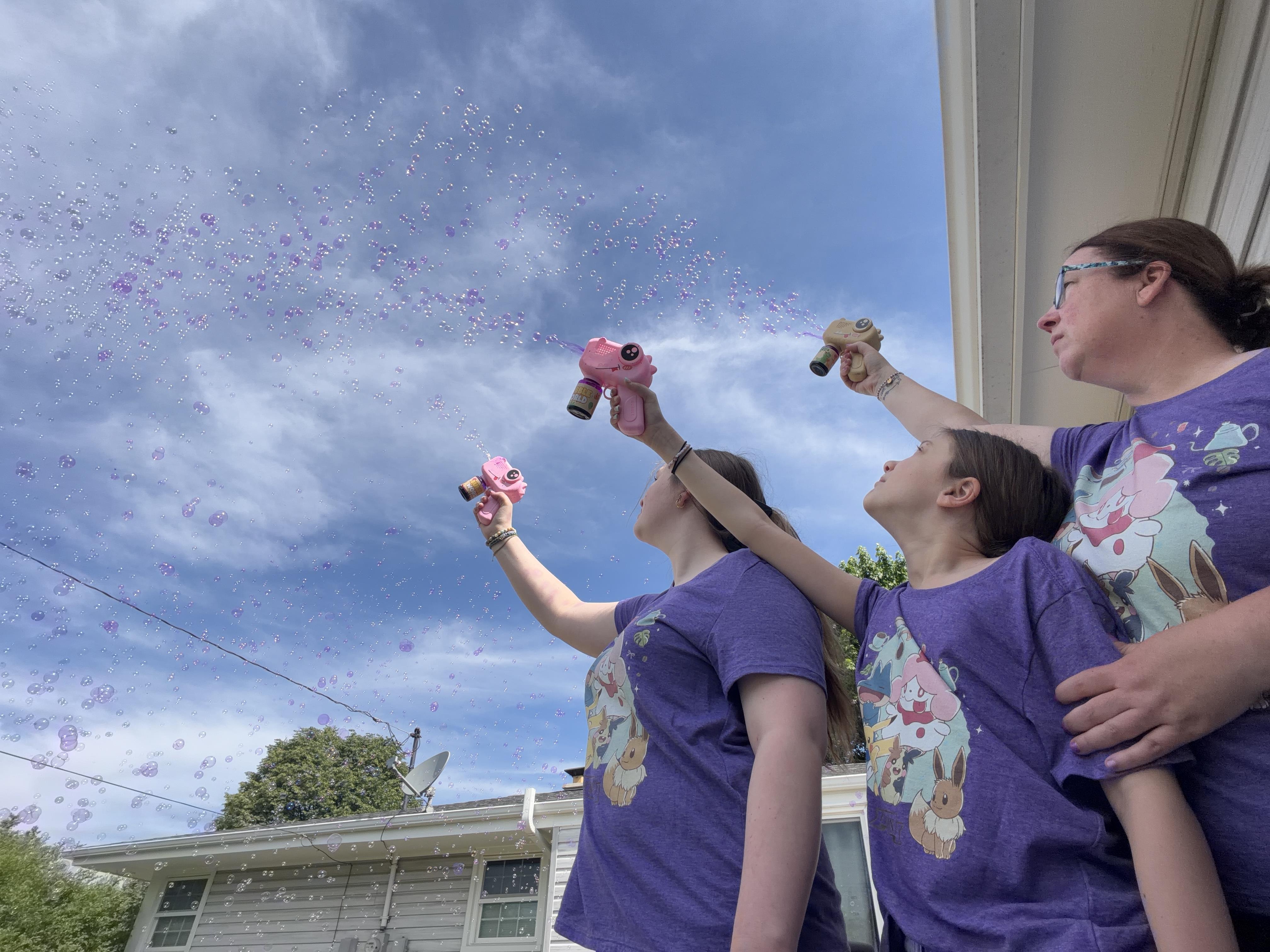 A group of people spraying bubbles