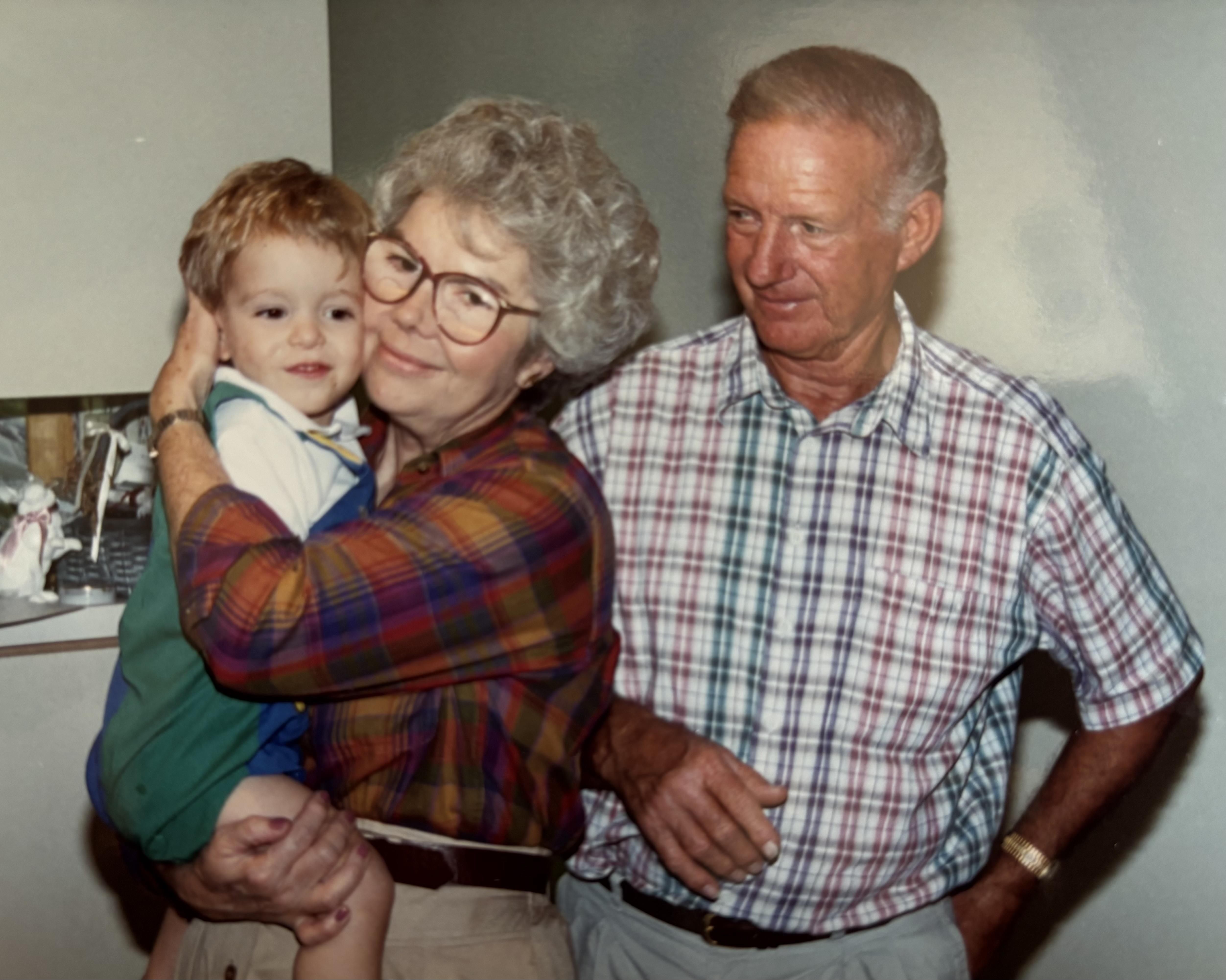 A man and woman holding a baby