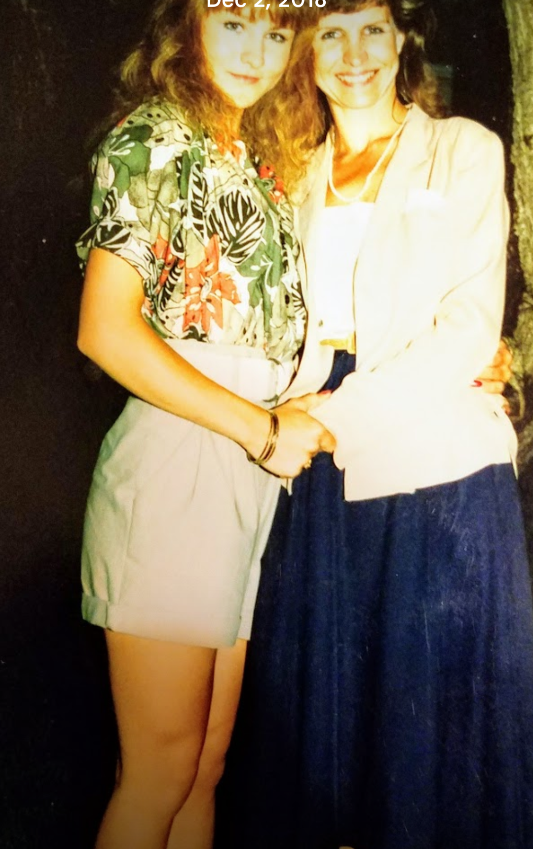 Two women standing together smiling