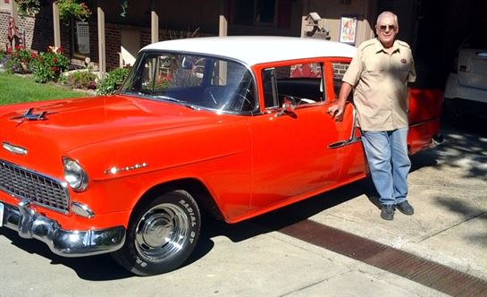 A man standing next to a car