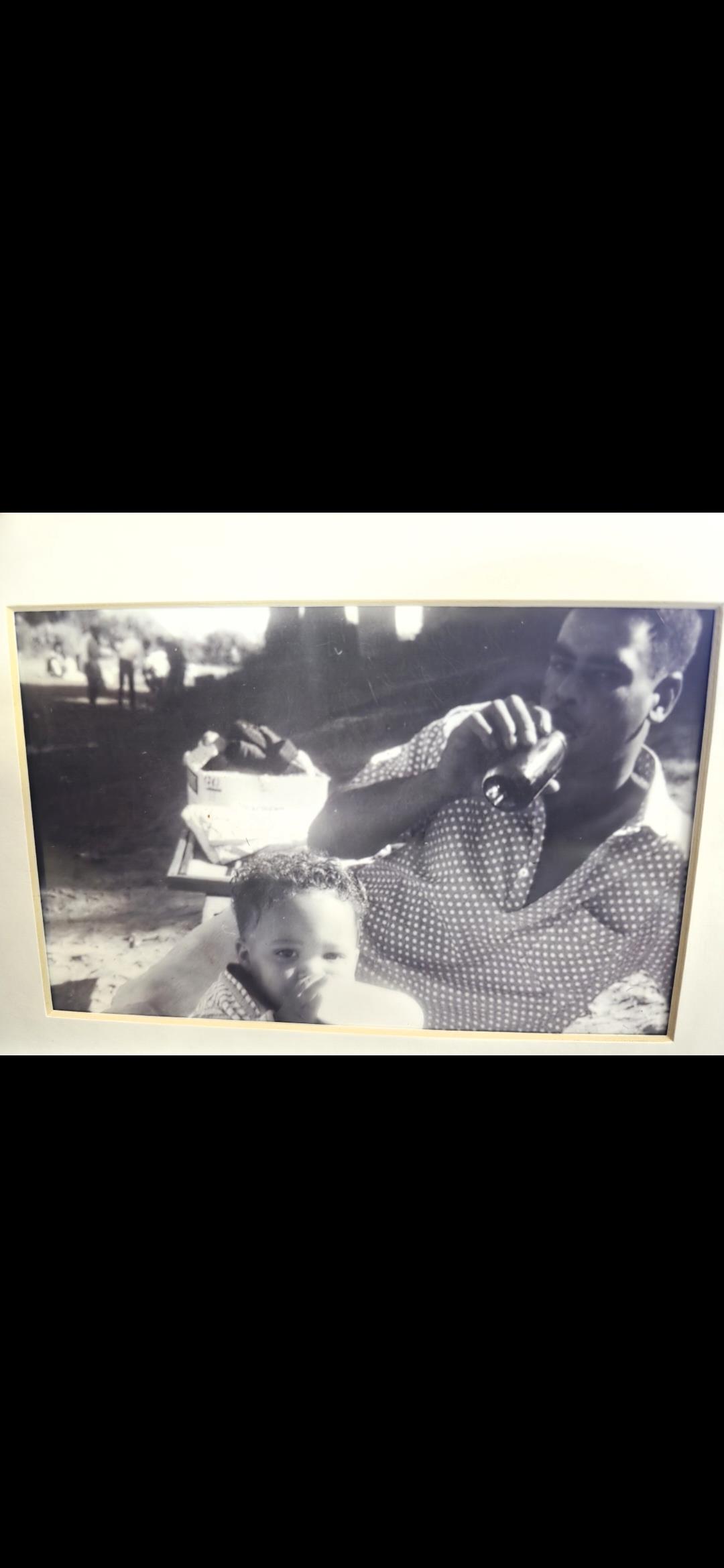 A man holding a bottle of soda