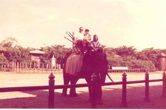 A group of people riding an elephant