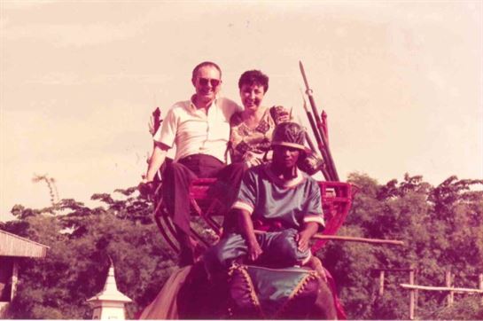 A group of people sitting on an elephant carriage