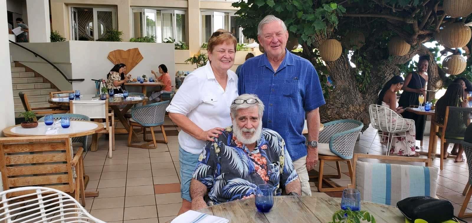 A group of people standing around a table