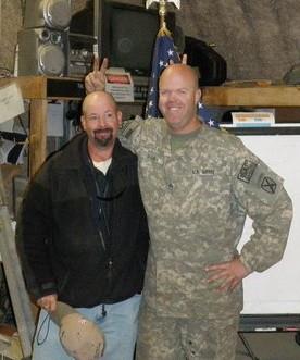 A man in military uniform with a man in front of him