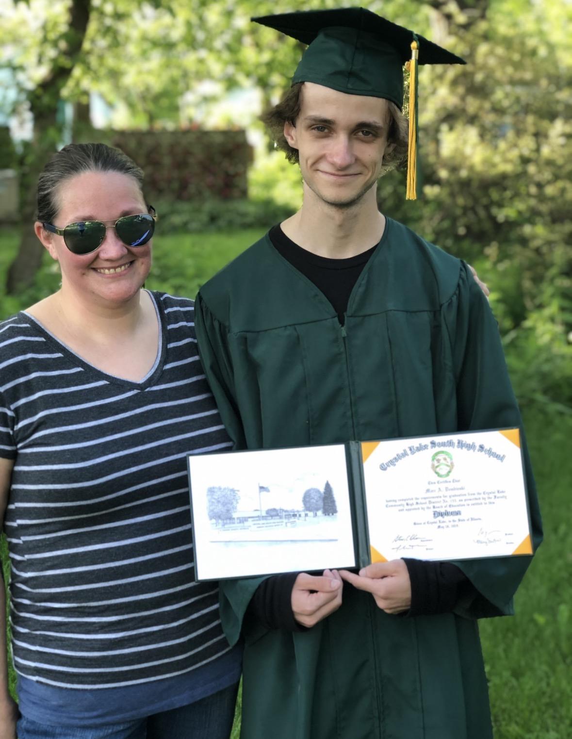 A man and woman holding certificates