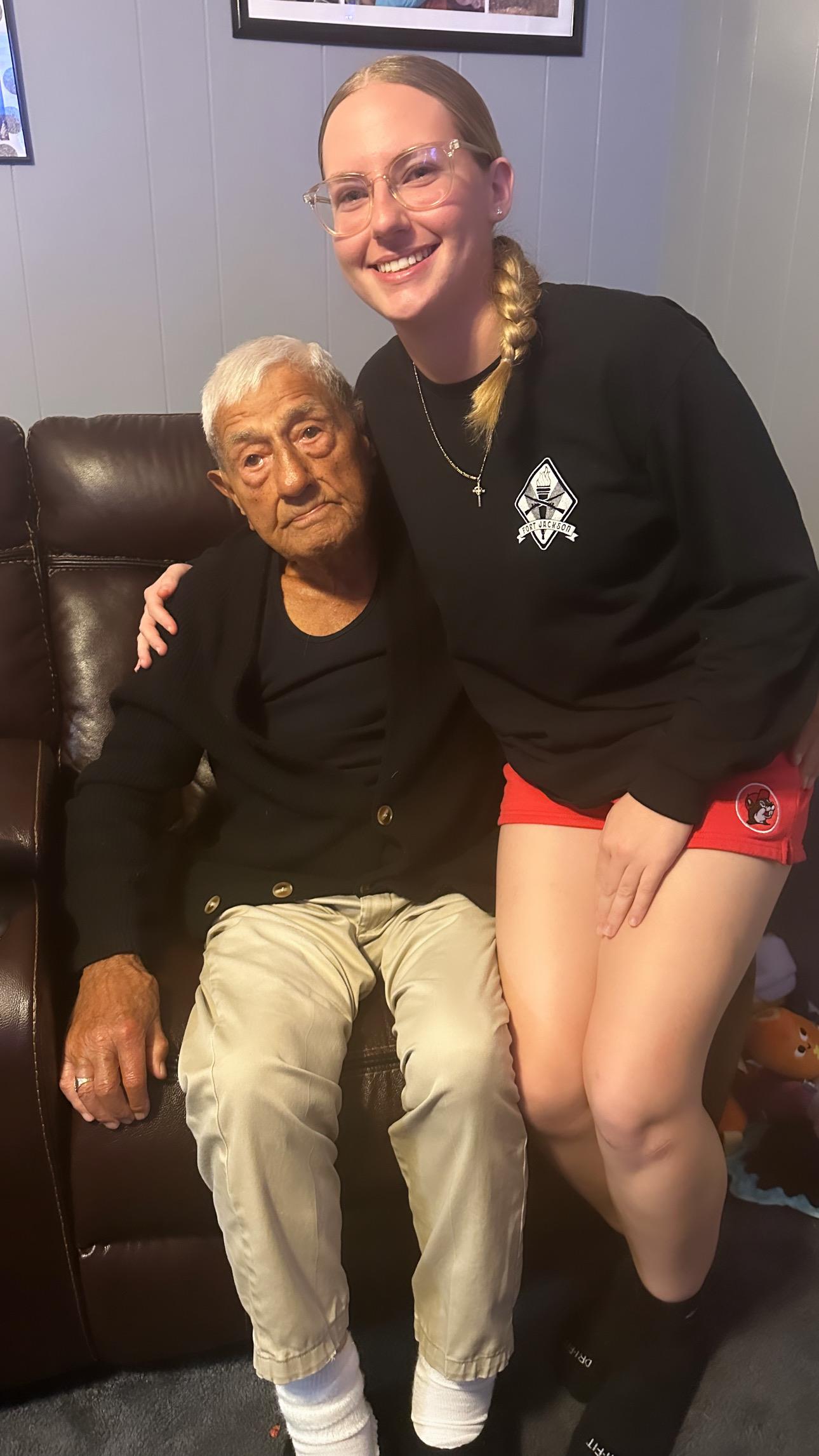 A woman hugging an old man
