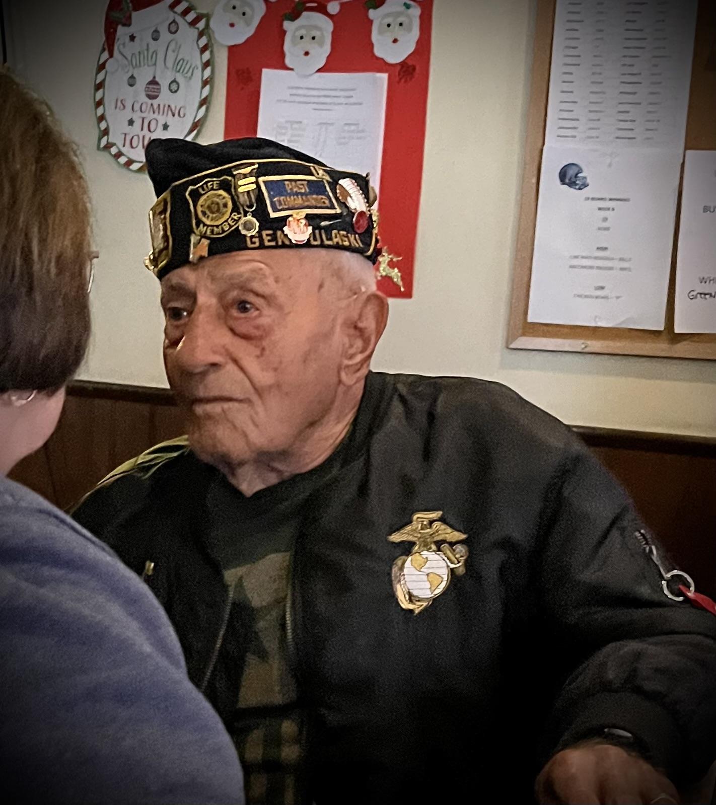 A man wearing a black hat with patches on his head