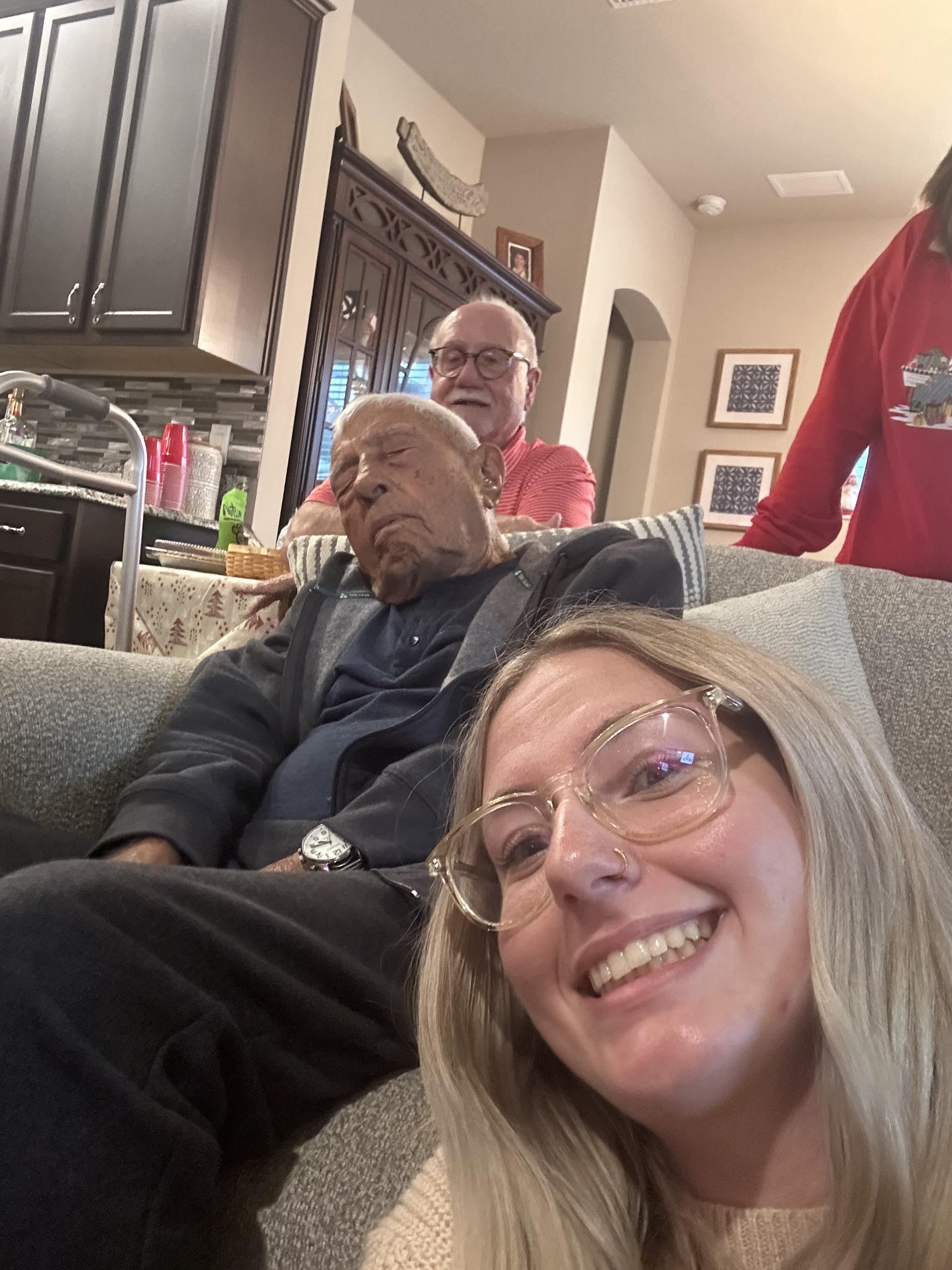 A woman taking a selfie with a group of people