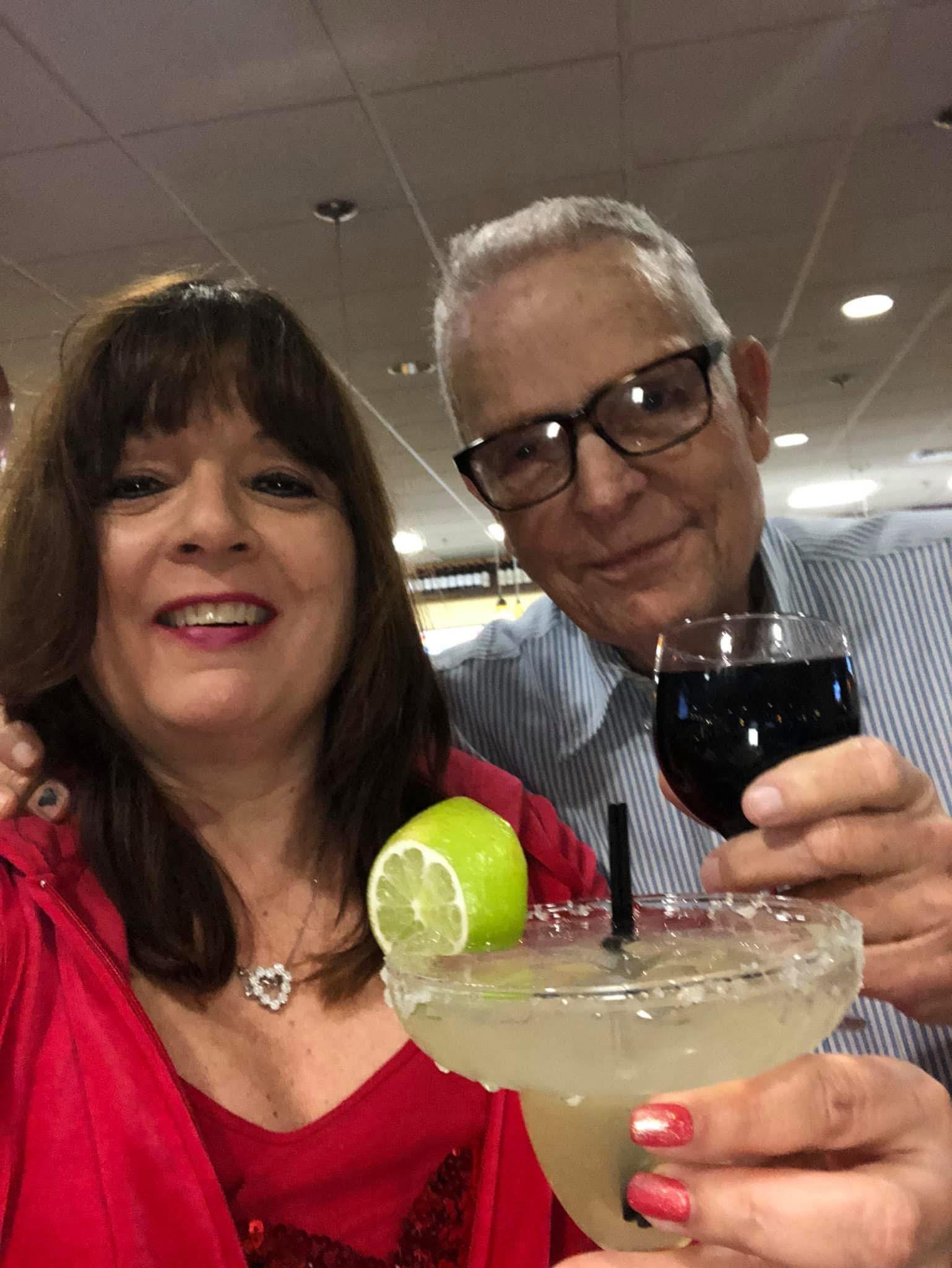 A man and woman holding a glass of wine