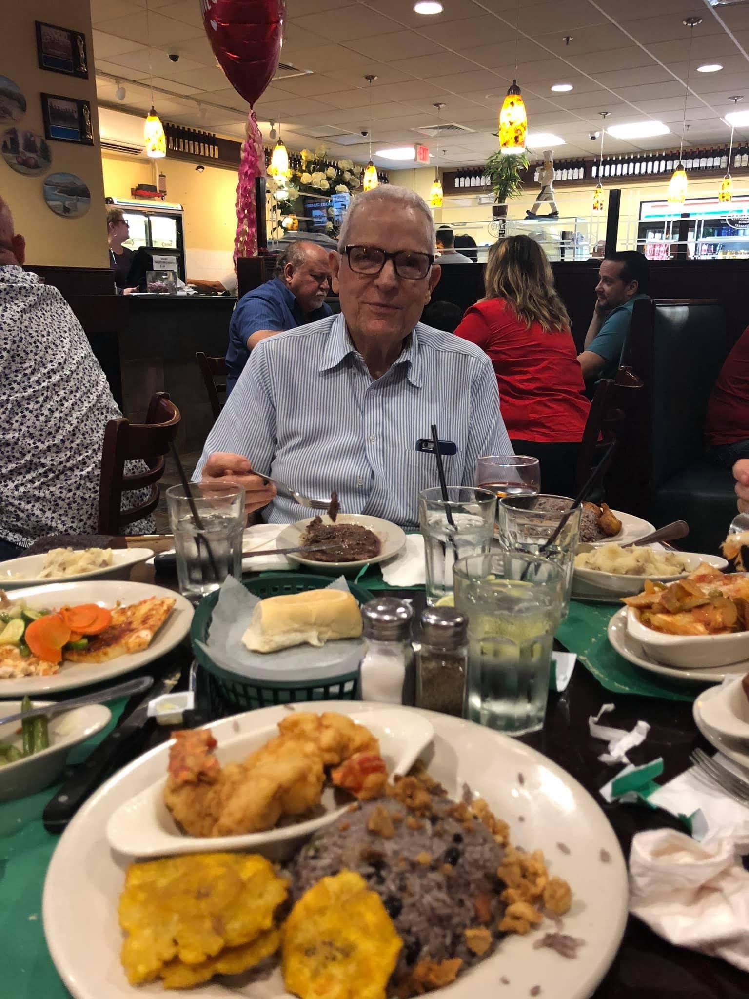 A man sitting at a table with food on it