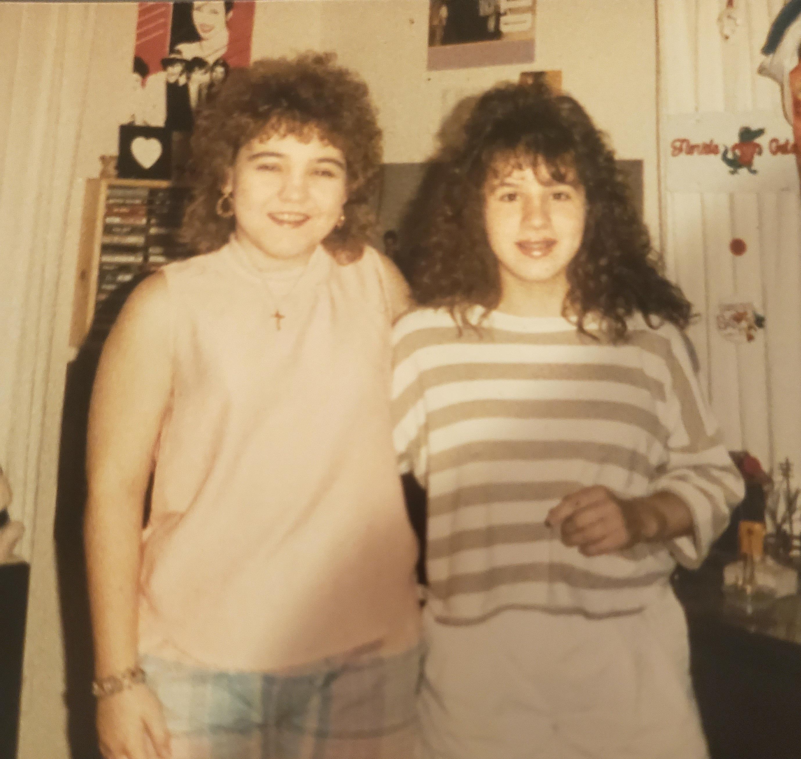 Two women standing together in a room