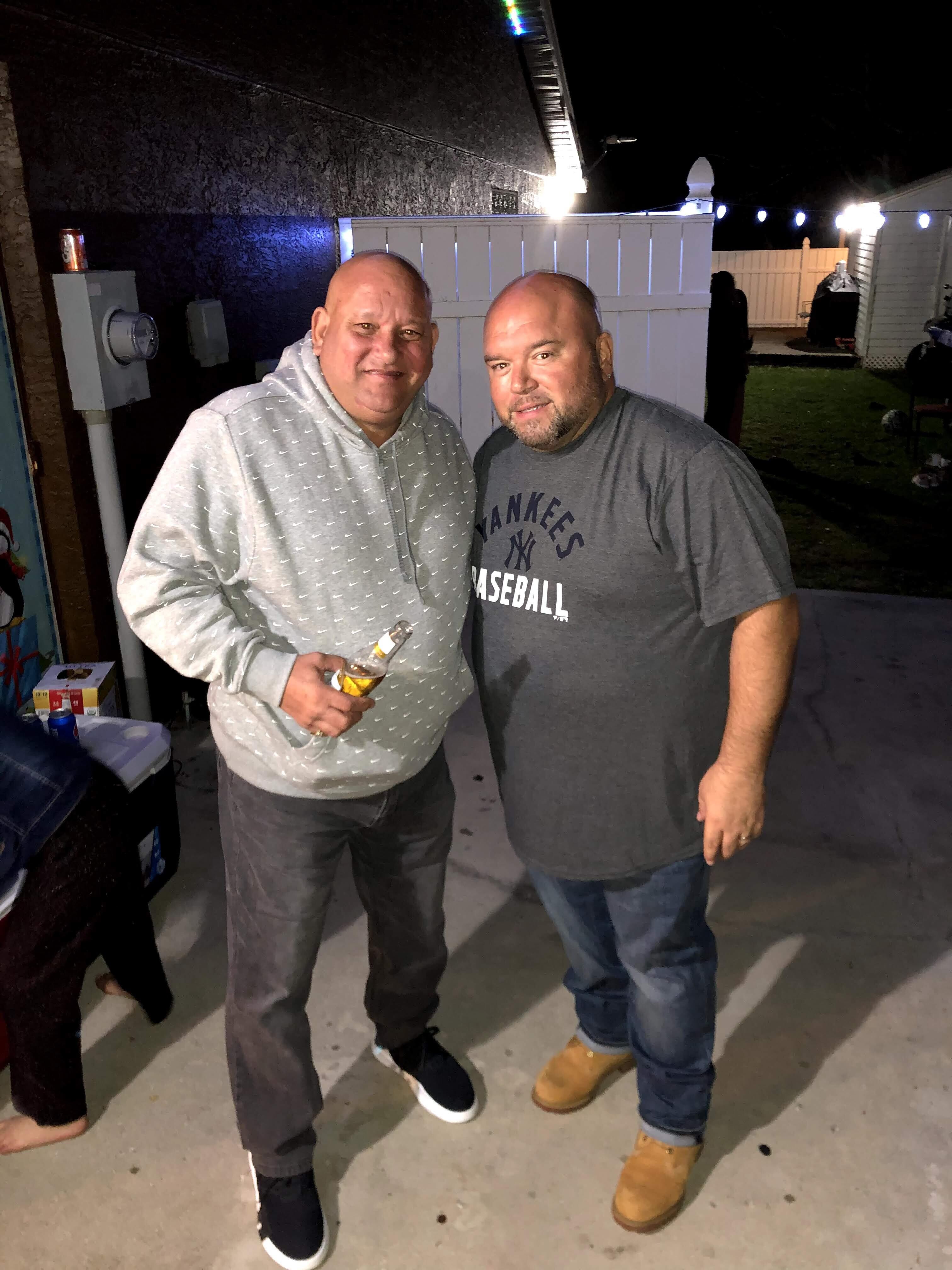 Two men standing together smiling