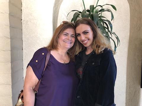 Two women standing together smiling