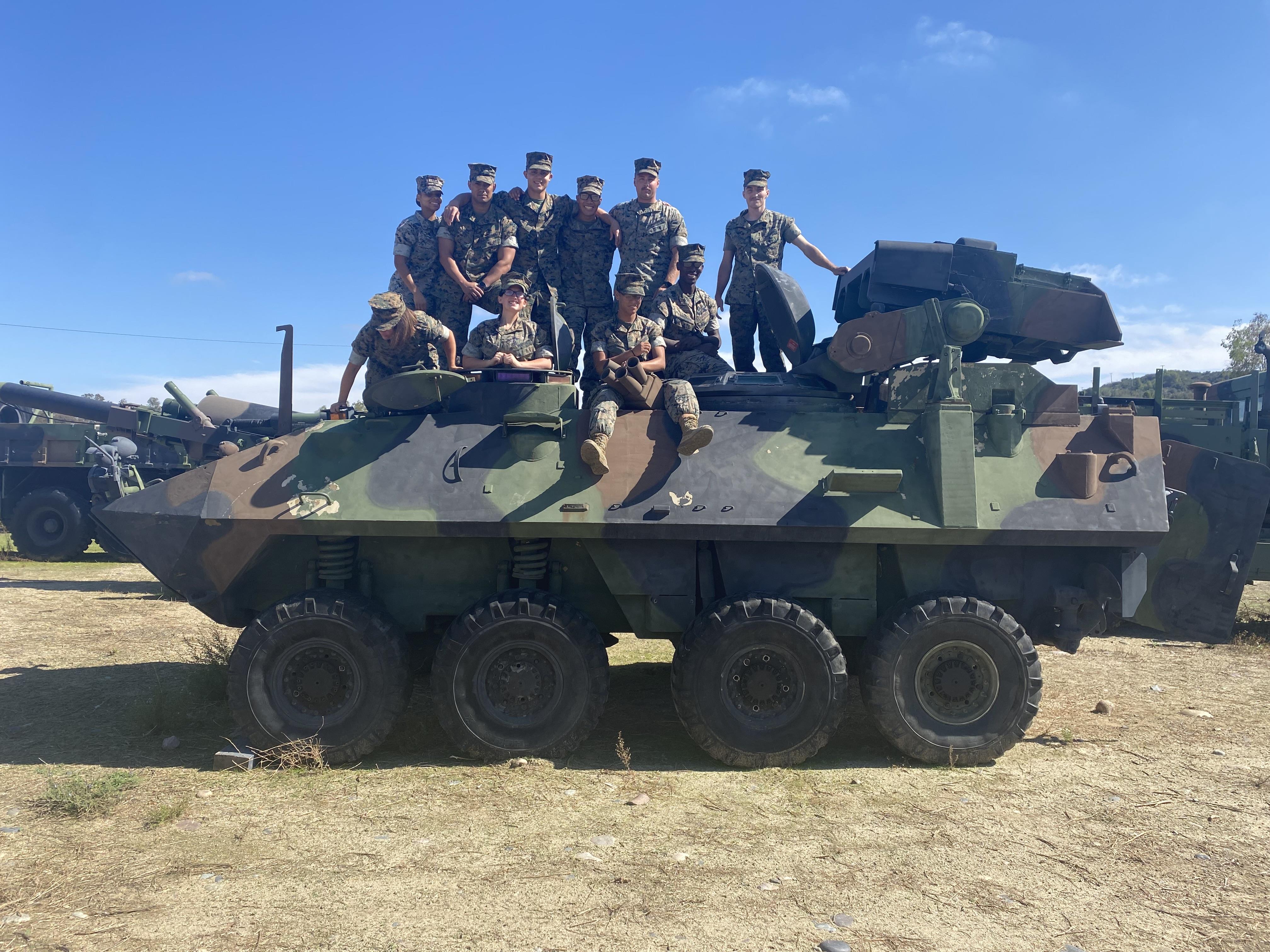 A group of people on a military vehicle