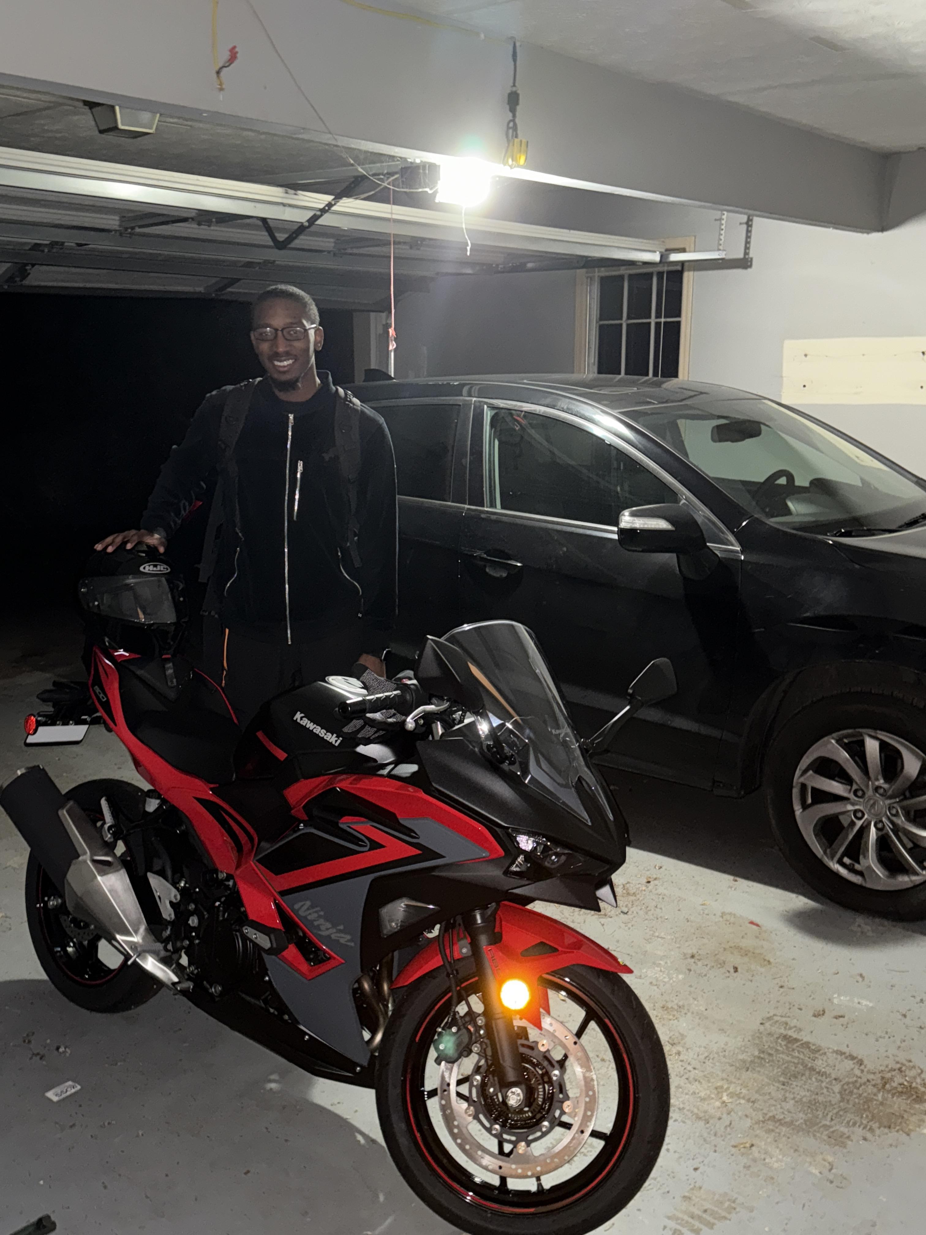 A man standing next to a motorcycle