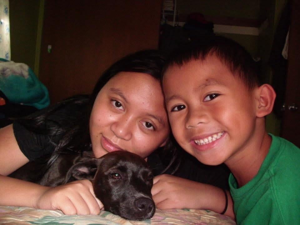 A woman and a boy with a dog