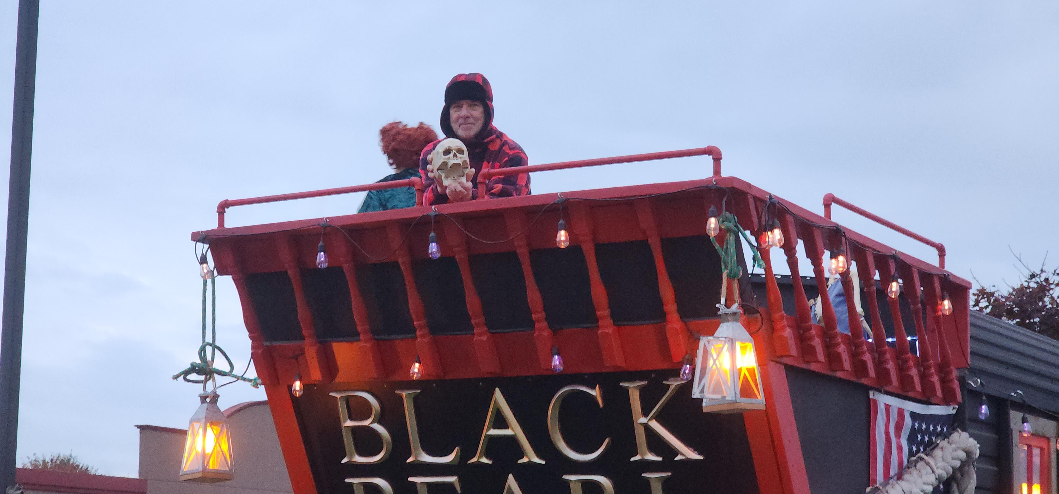 A man standing on top of a red bus