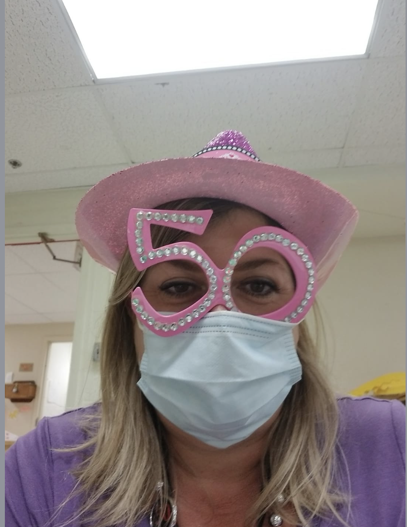 A woman wearing a pink hat and glasses