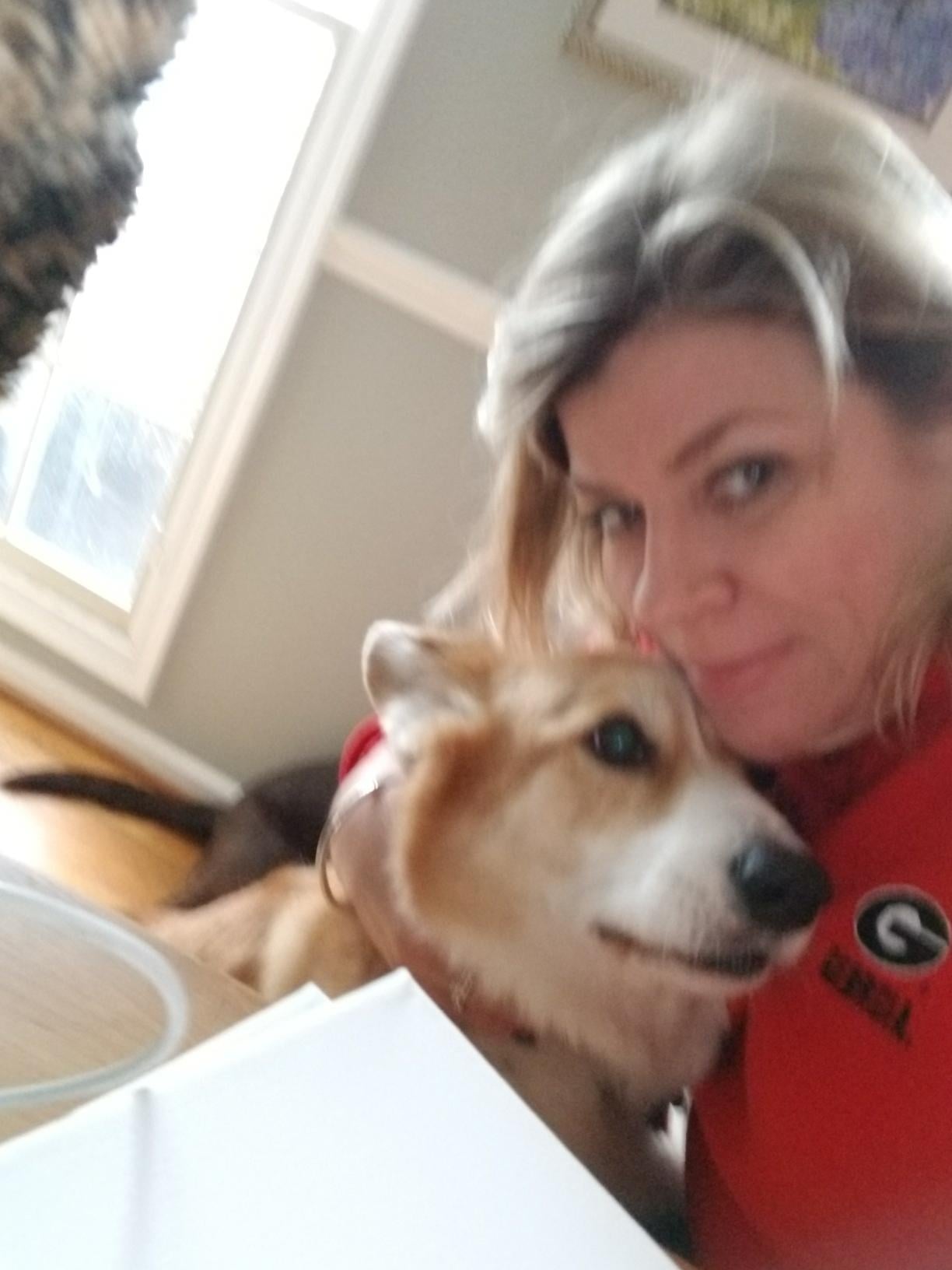 A woman holding a dog