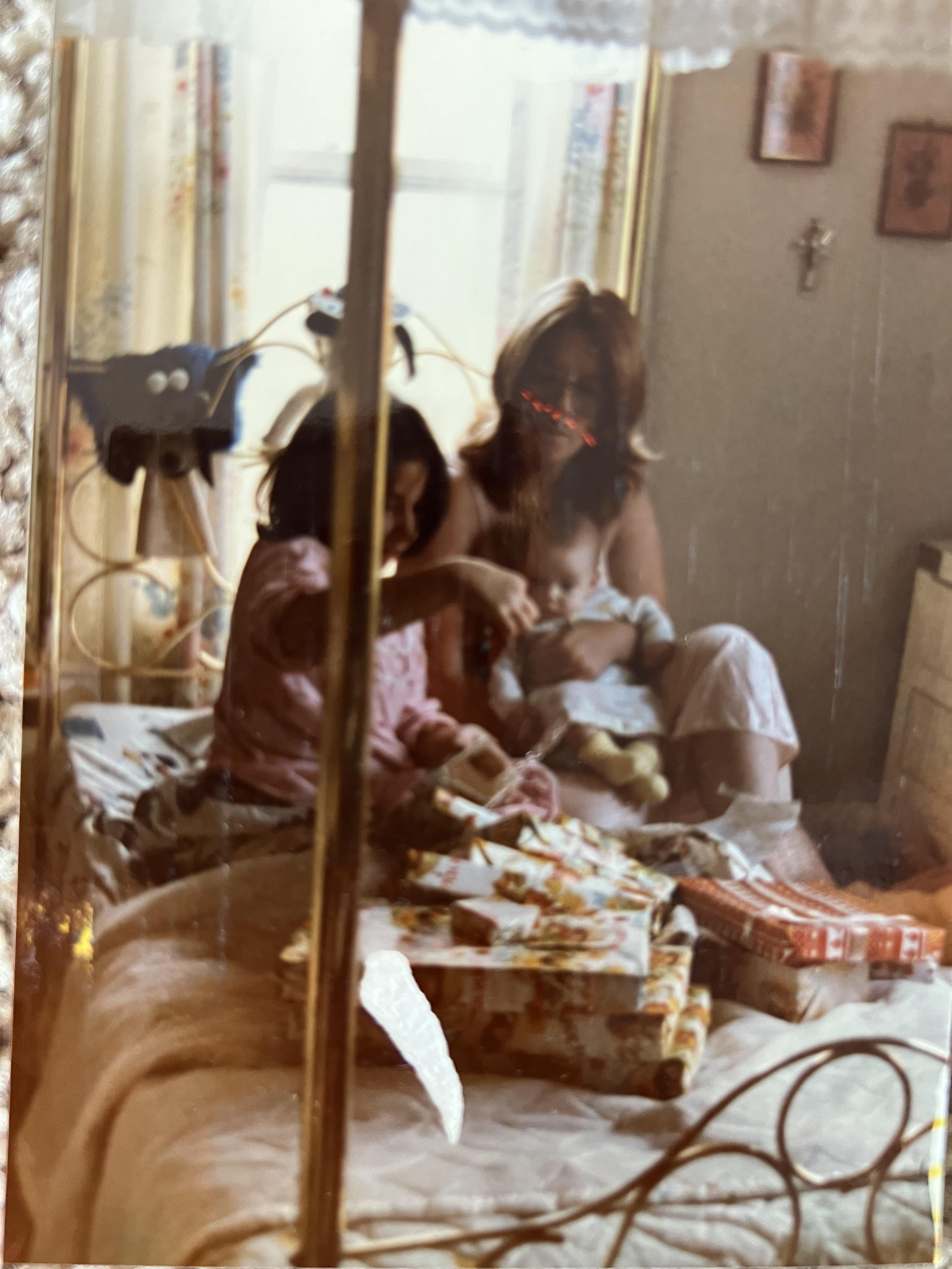 A group of people sitting on a bed with presents