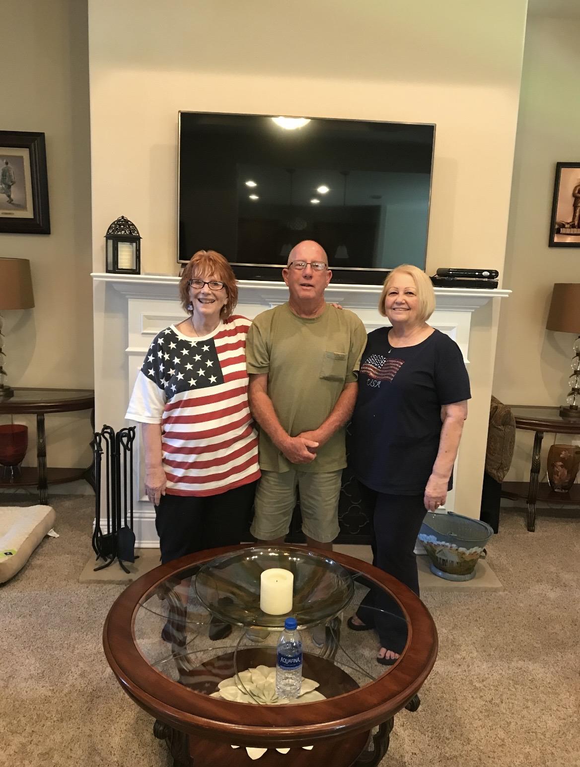 A group of people standing in a living room