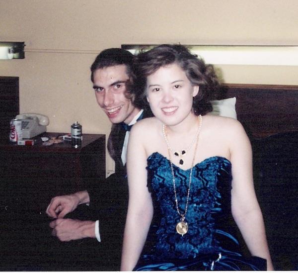 A man and woman sitting on a bed