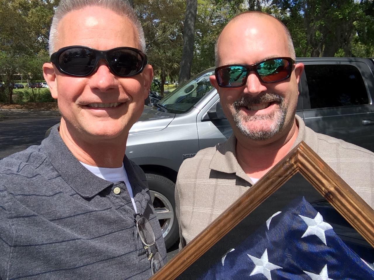 Two men holding a flag
