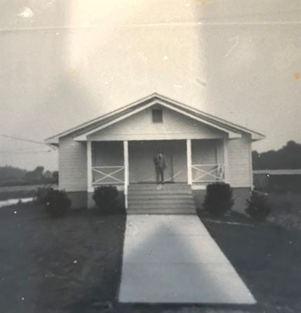 A man standing on the porch of a house