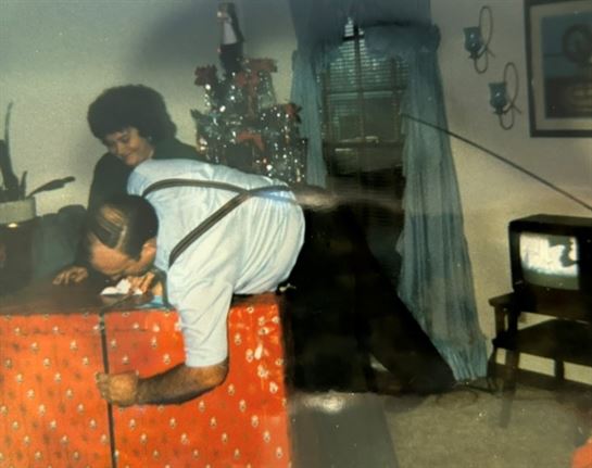 A man and woman sitting on a table