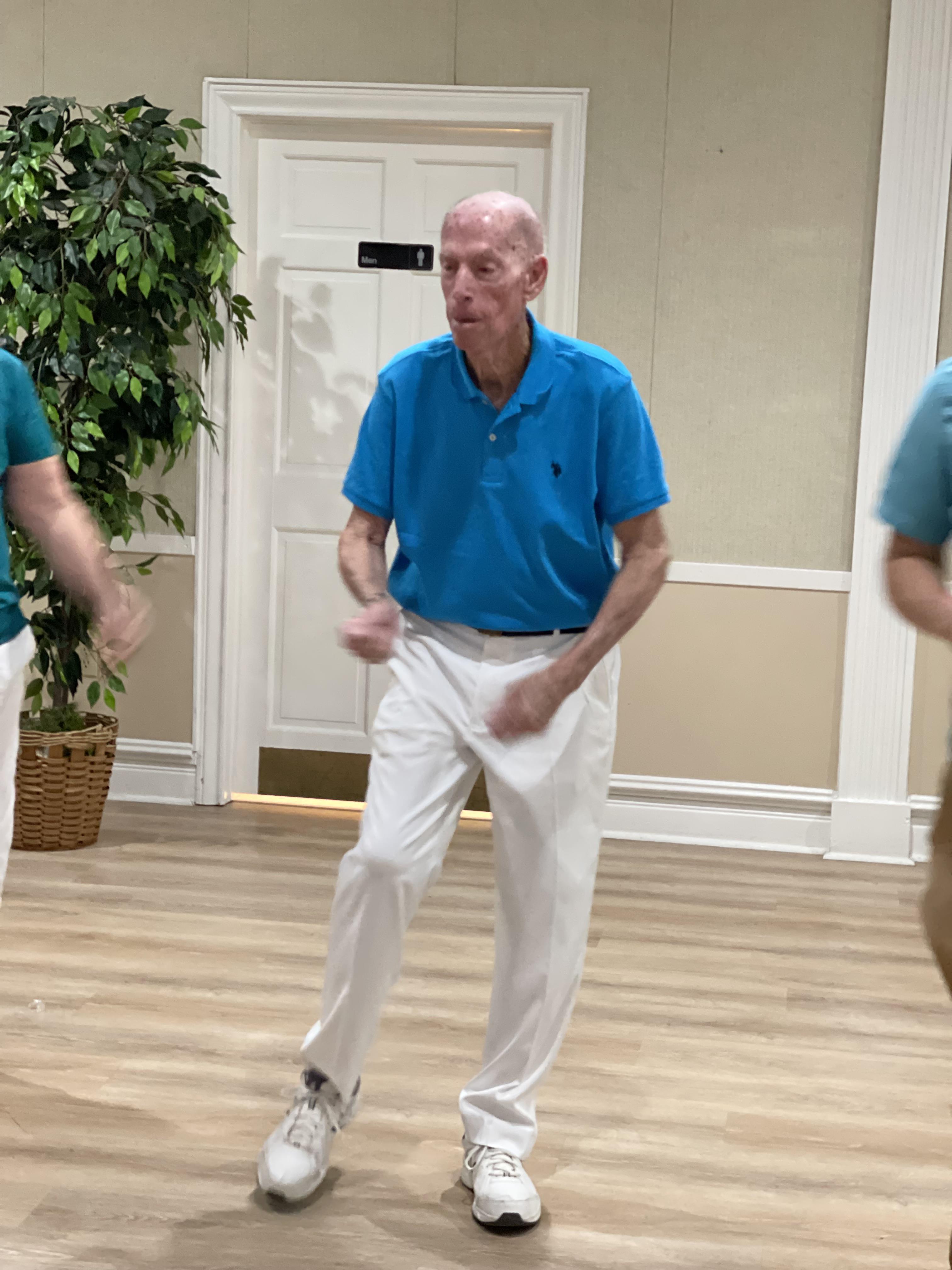 A man in a blue shirt dancing