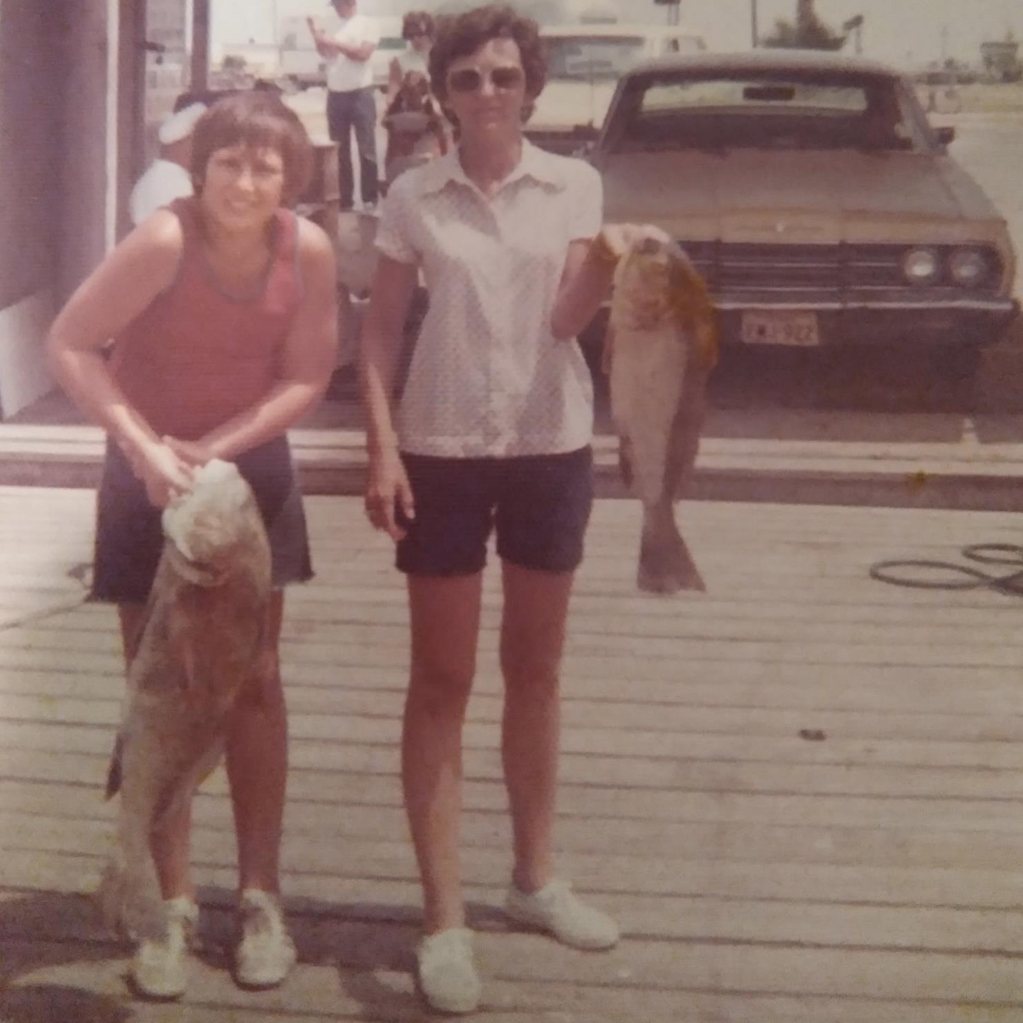 A man and woman holding a dog