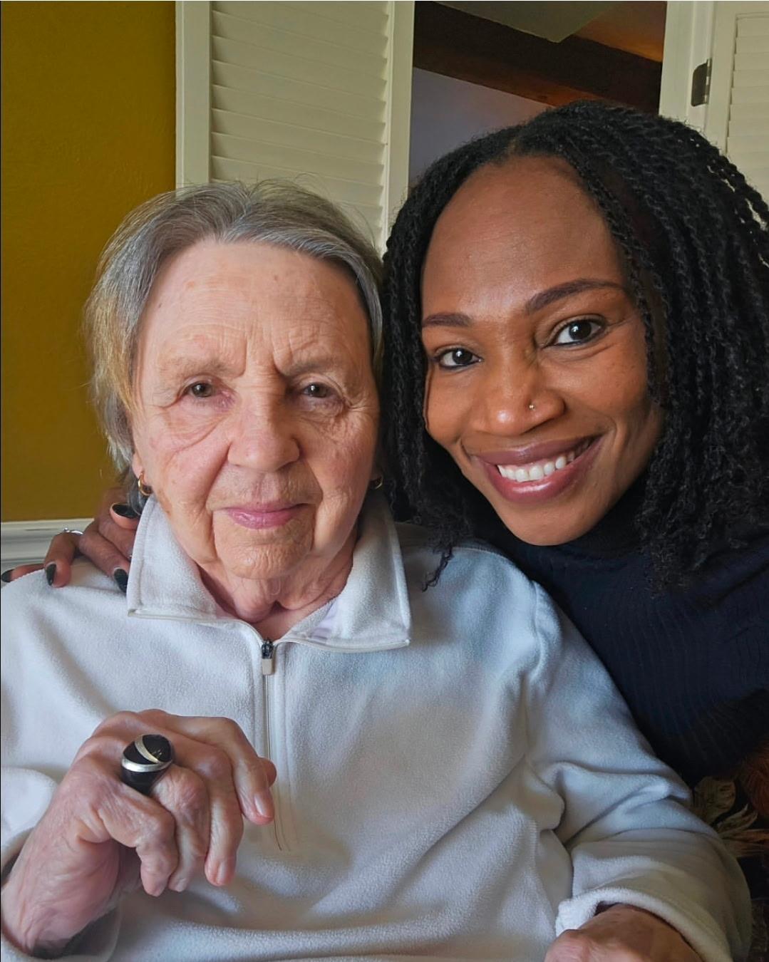 A woman and a woman smiling