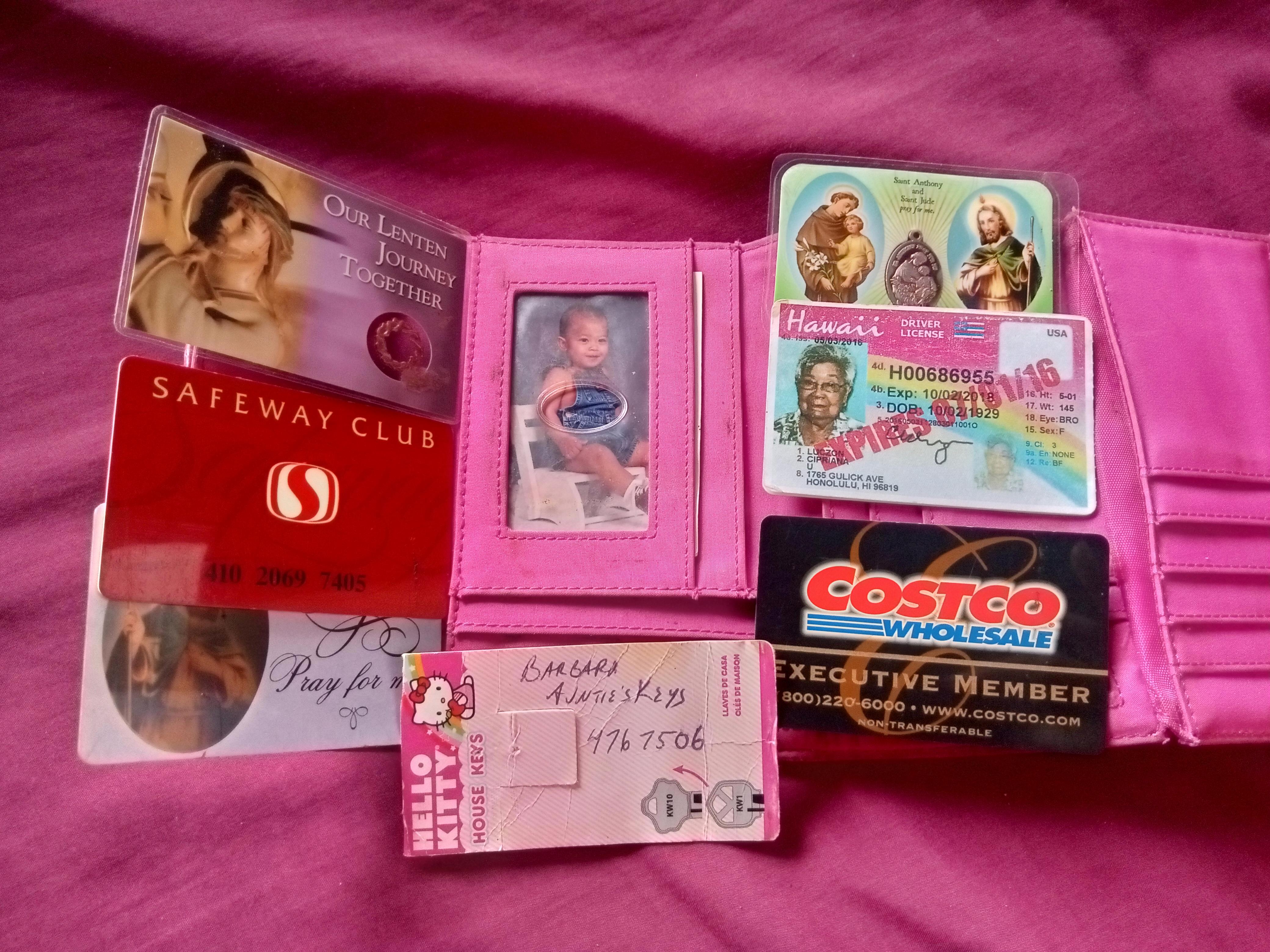 A wallet with cards and a picture of a child