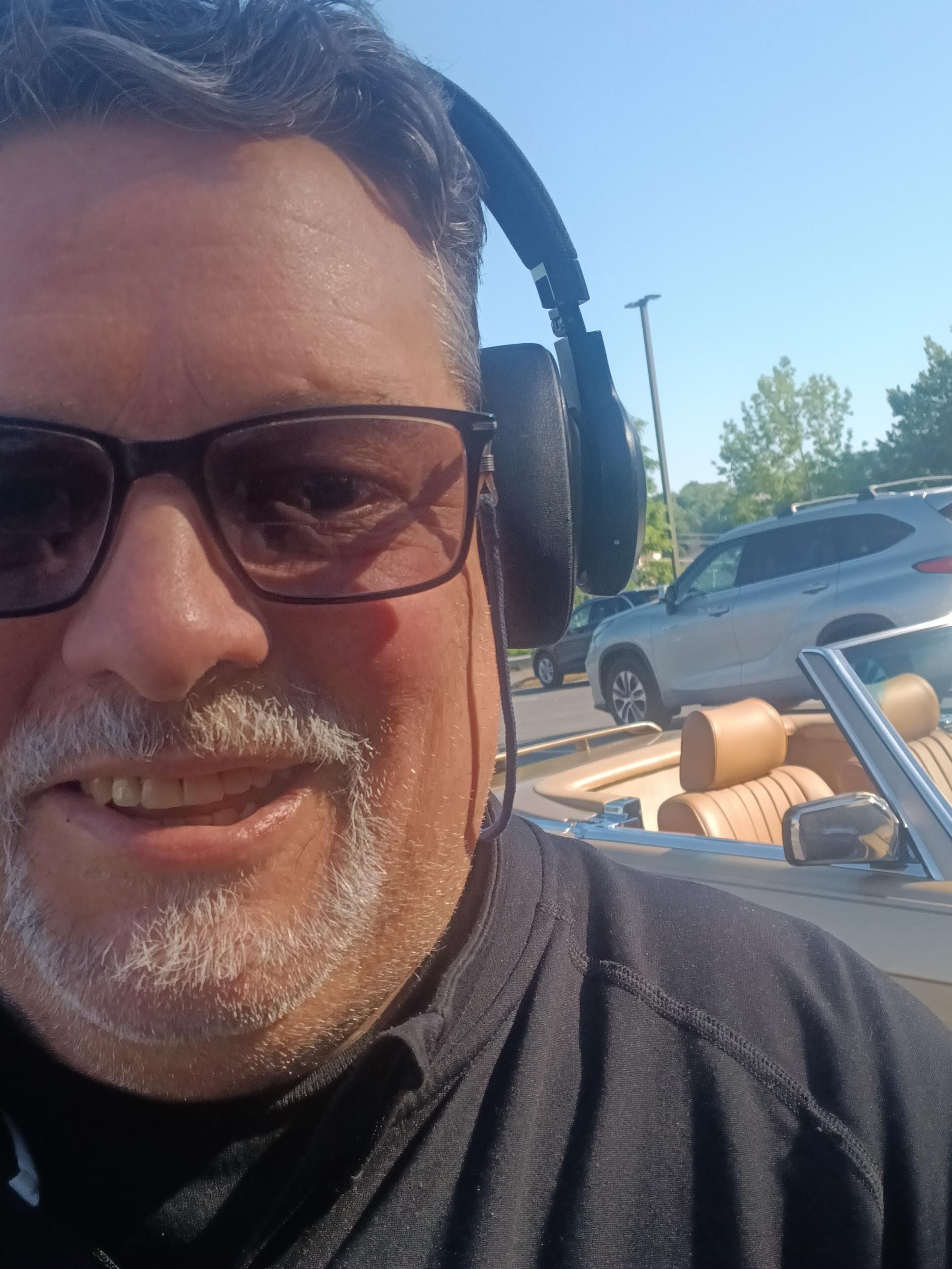 A man wearing headphones and sunglasses