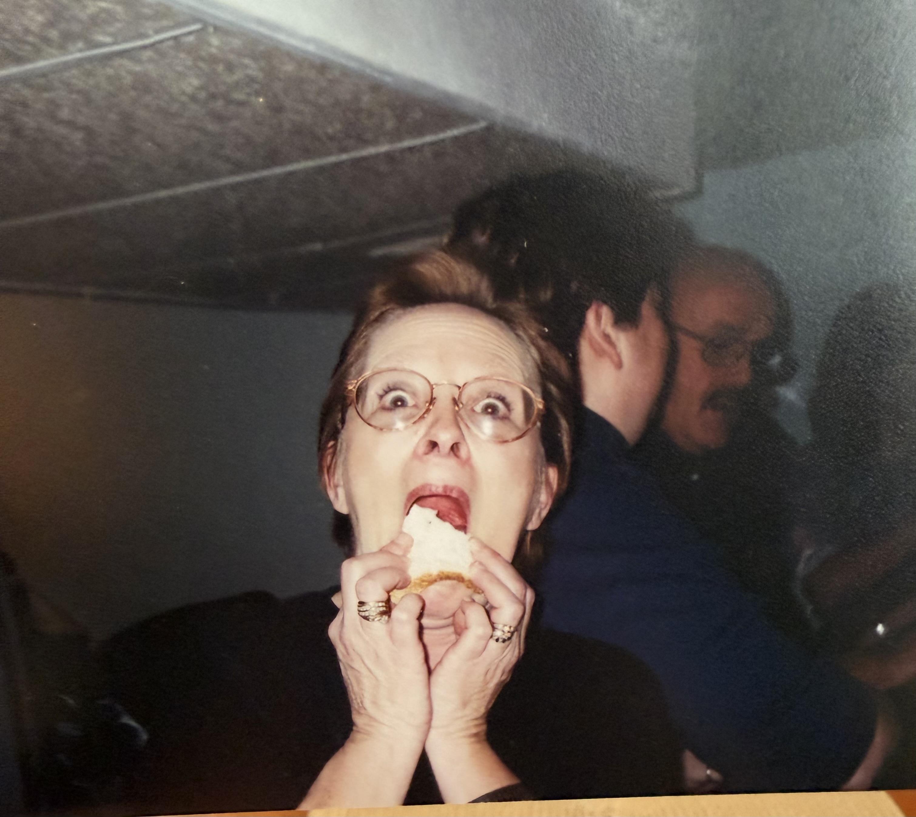A woman eating a piece of food