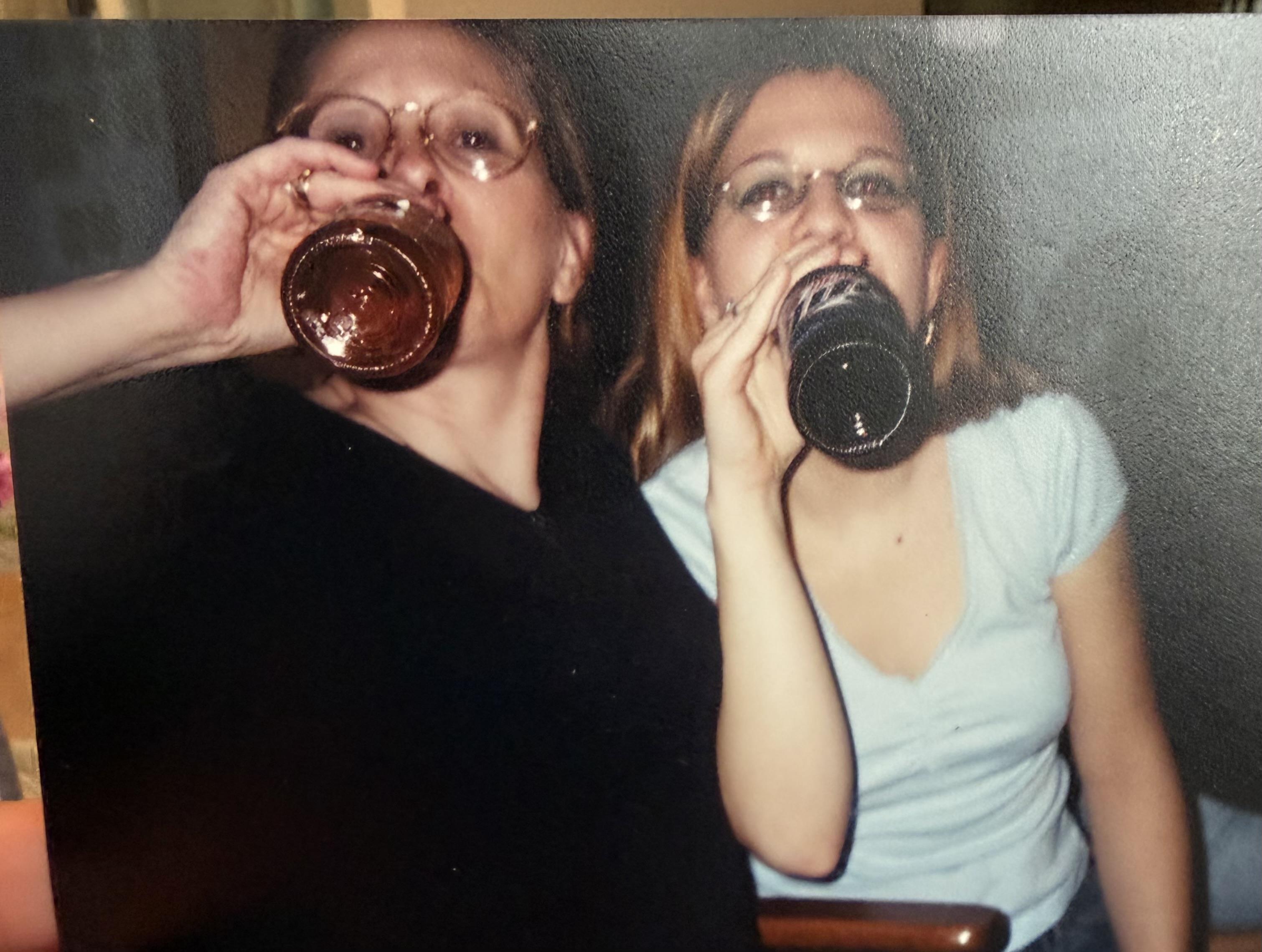 Two women drinking from bottles