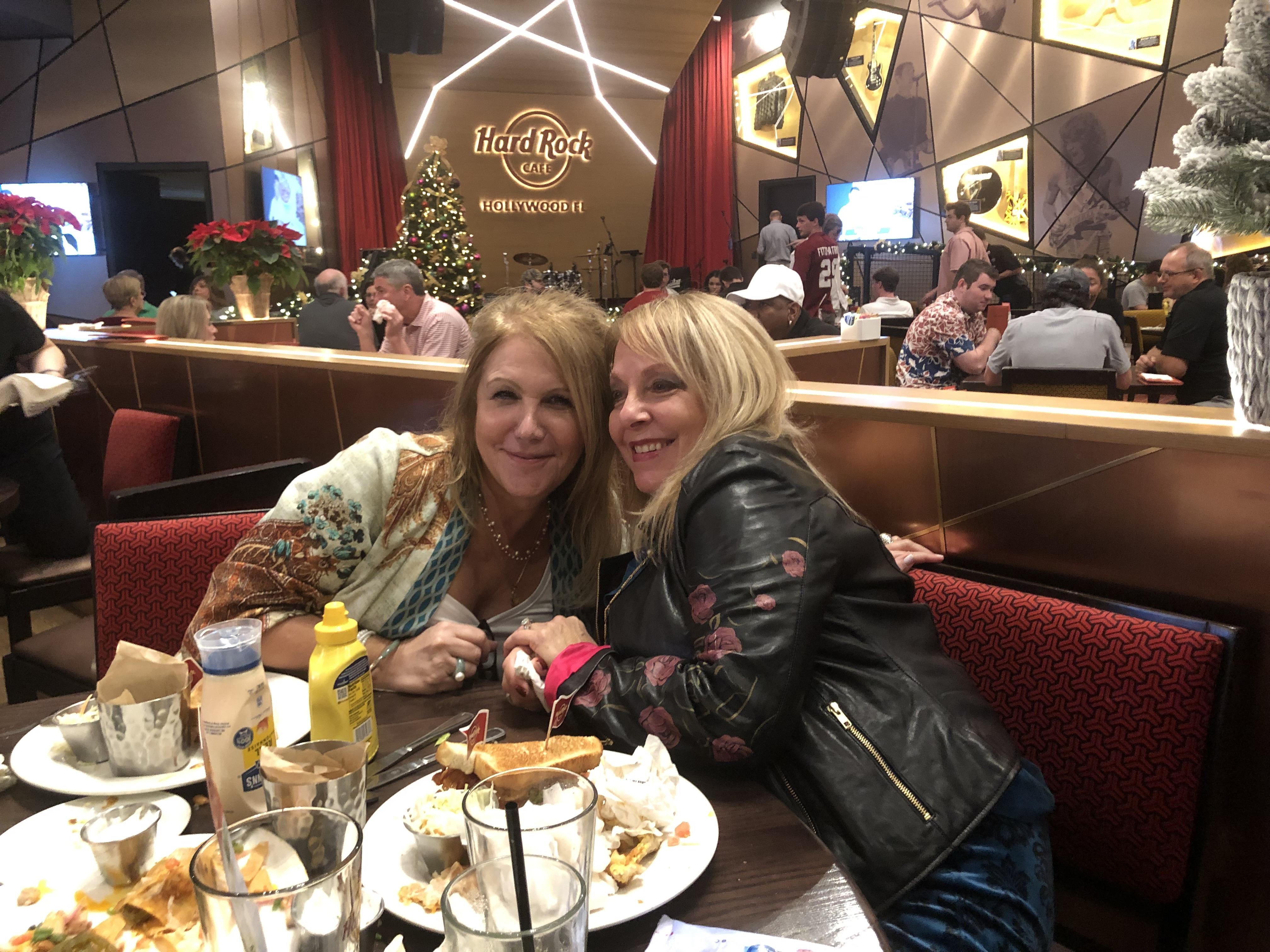 Two women sitting at a table with food