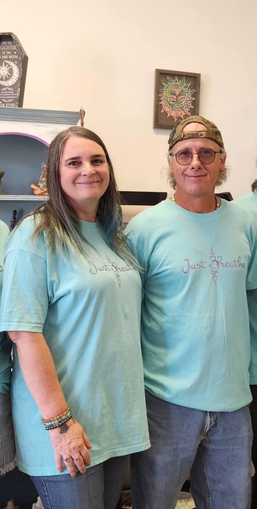 A man and woman wearing matching shirts