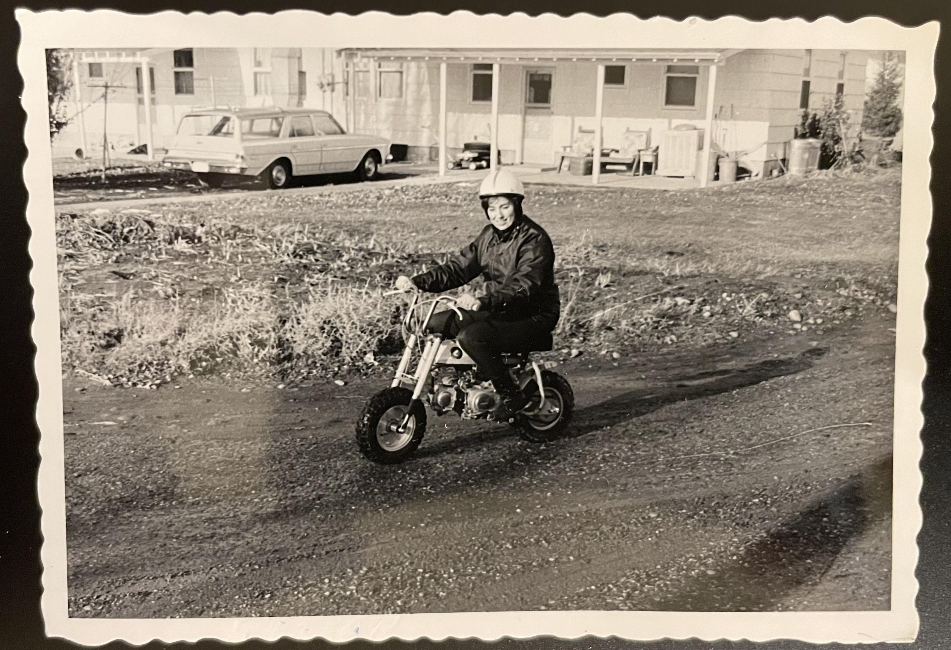 A man riding a small motorcycle