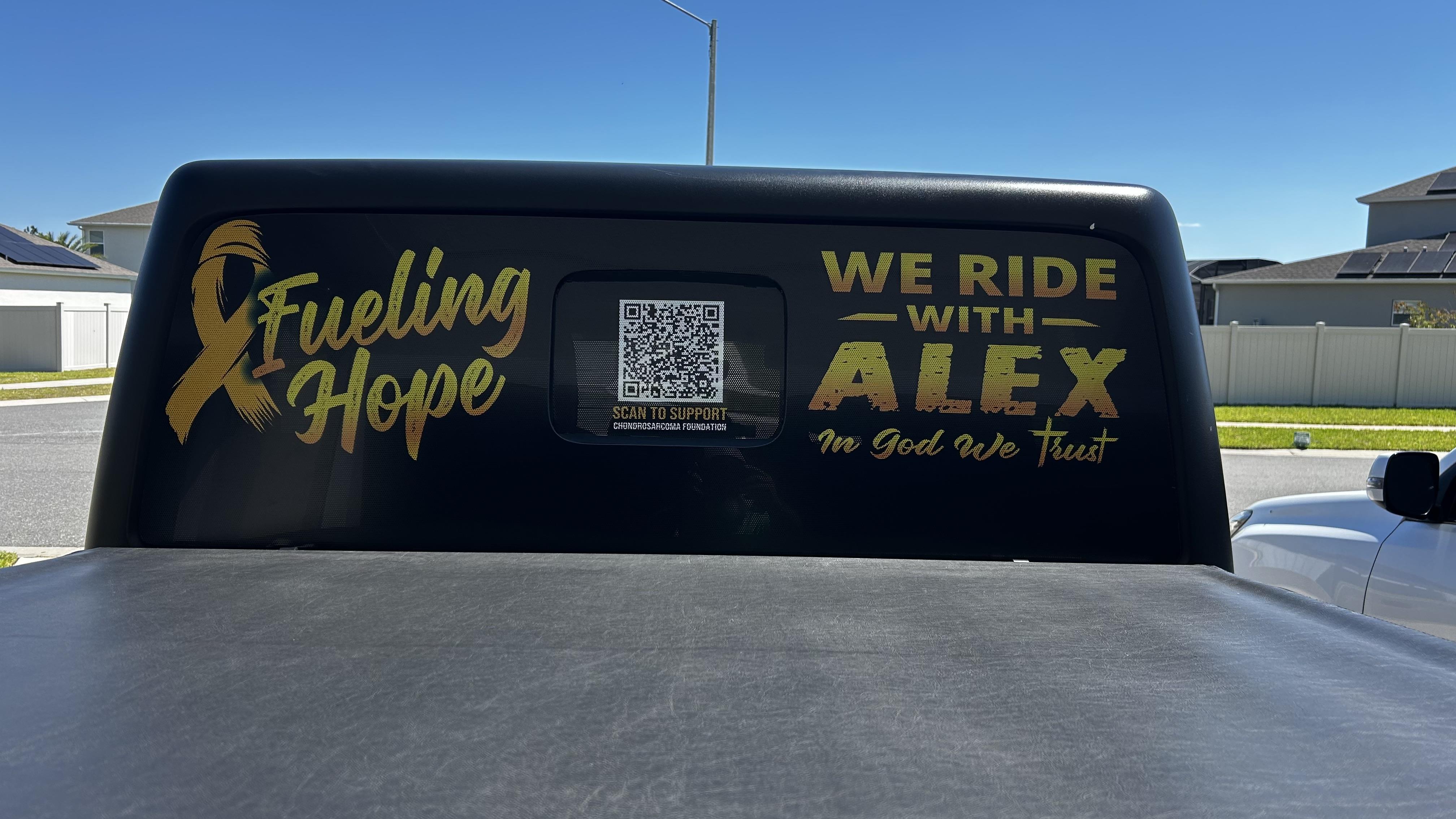 A black van with gold text on it