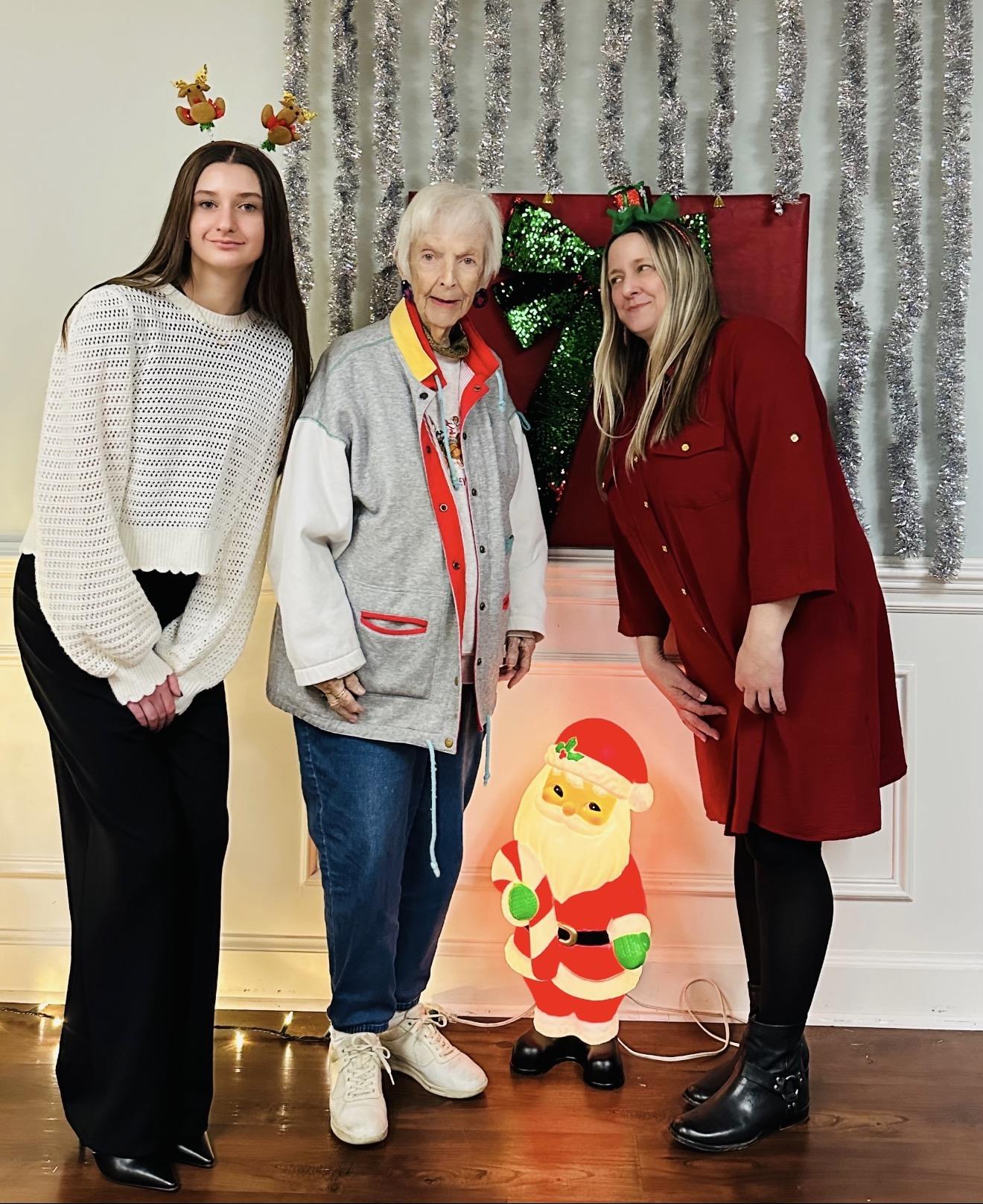 A group of women standing next to a santa claus