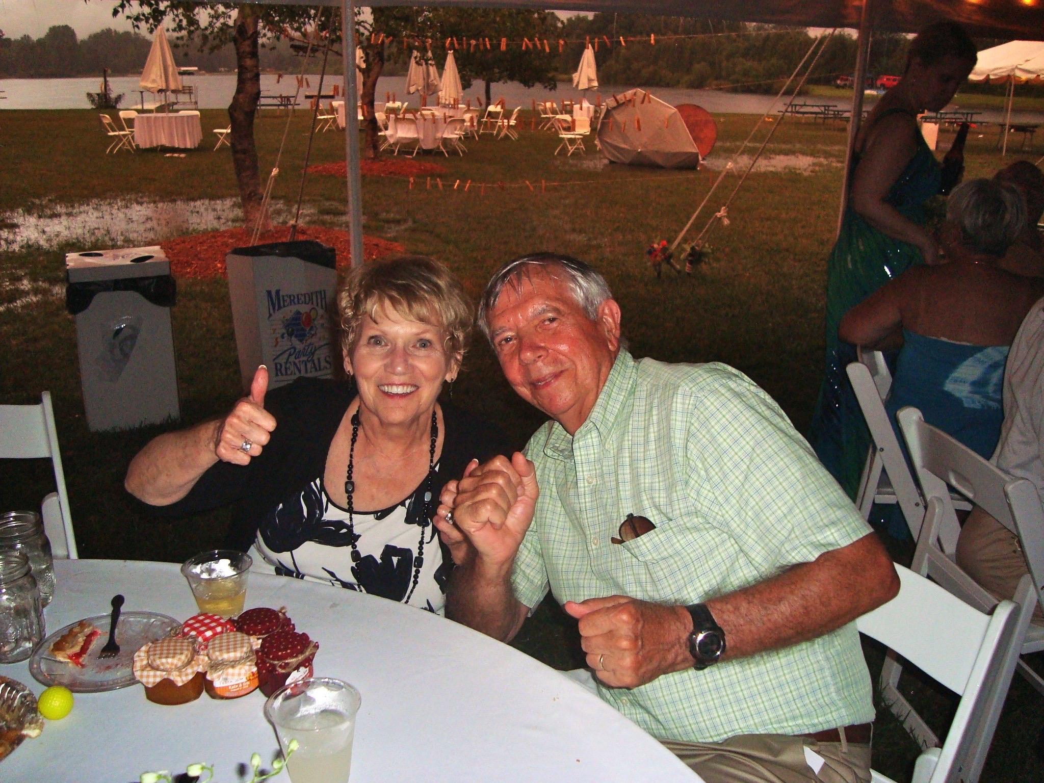 A man and woman giving thumbs up