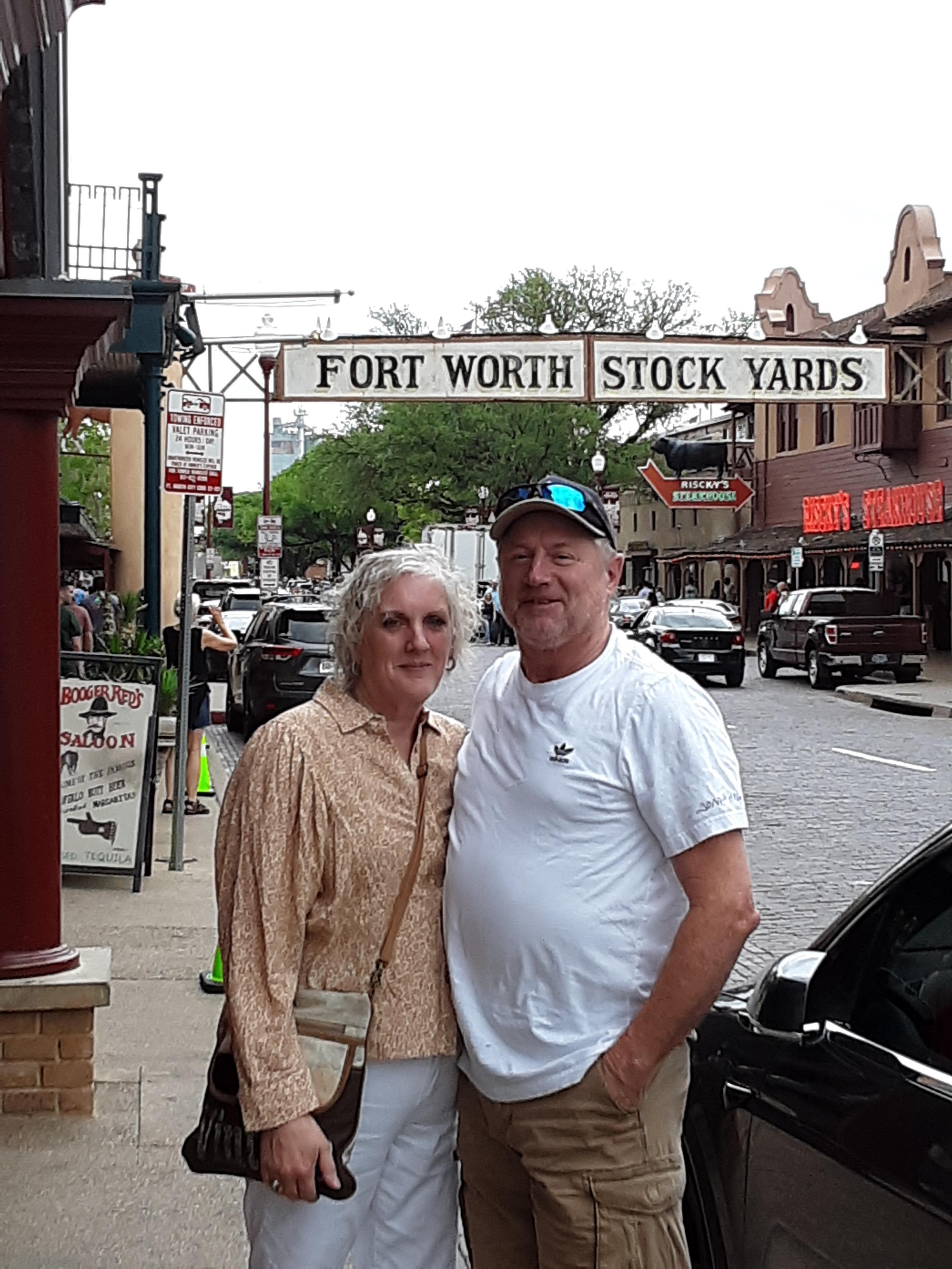 A man and woman standing on a sidewalk