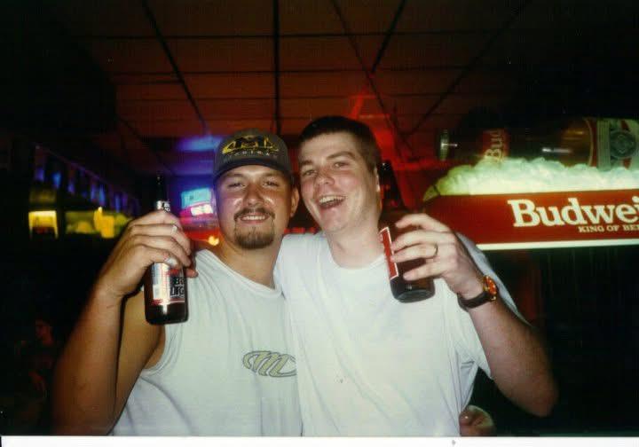 Two men holding bottles of beer