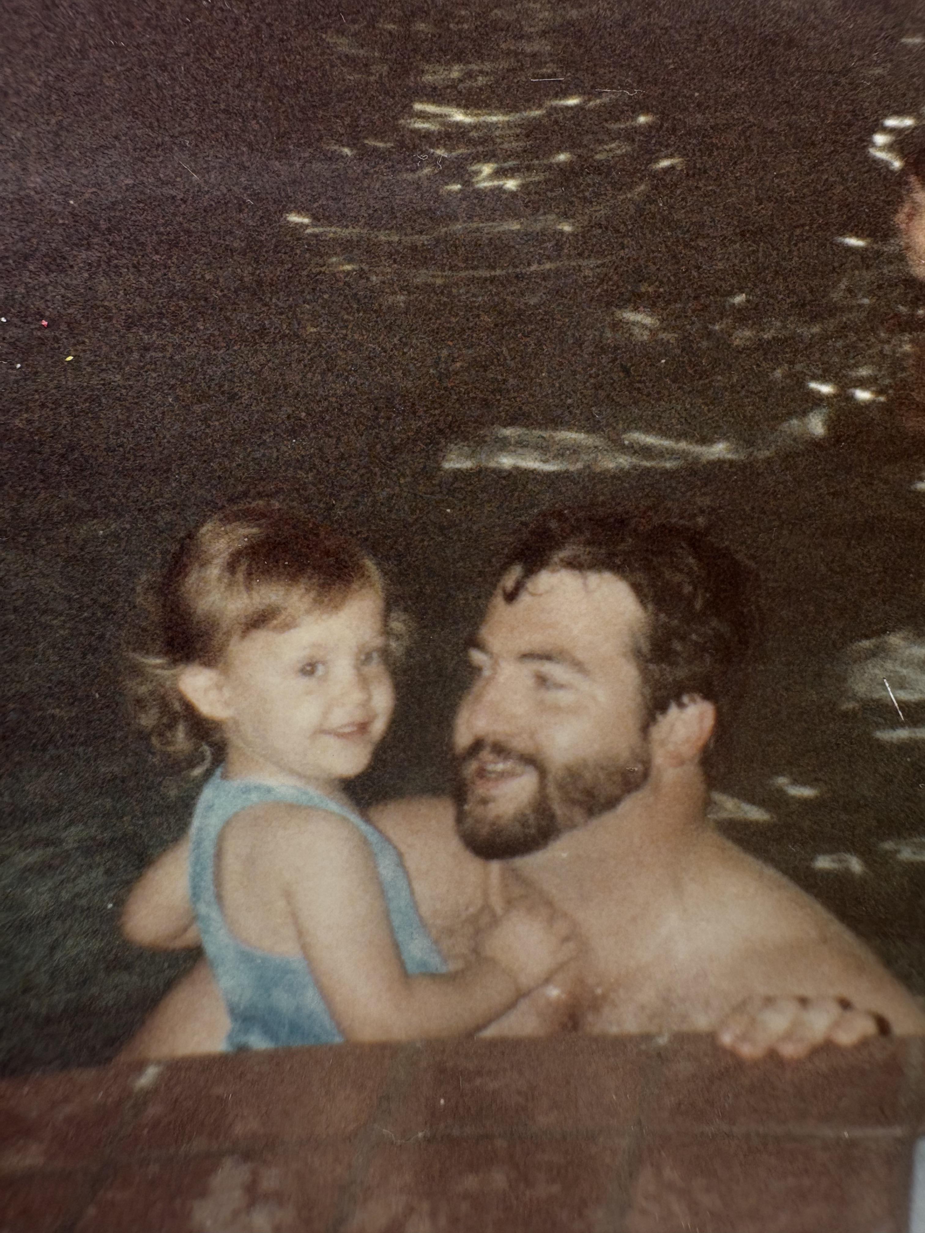 A man and child in a pool